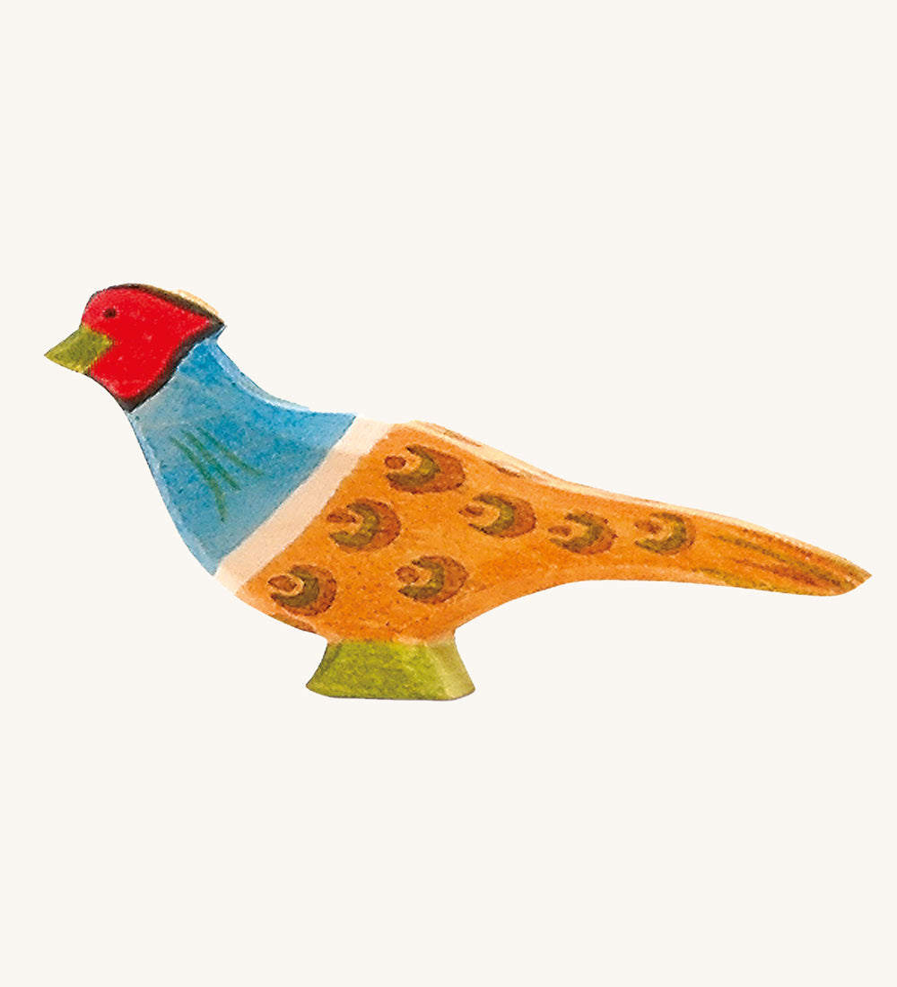 Ostheimer pheasant wooden toy figure on a plain background. 