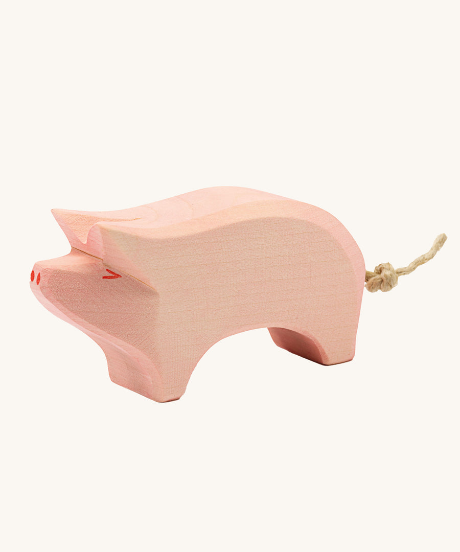 Ostheimer Pig toy figure with it's Head held High on a plain background. 