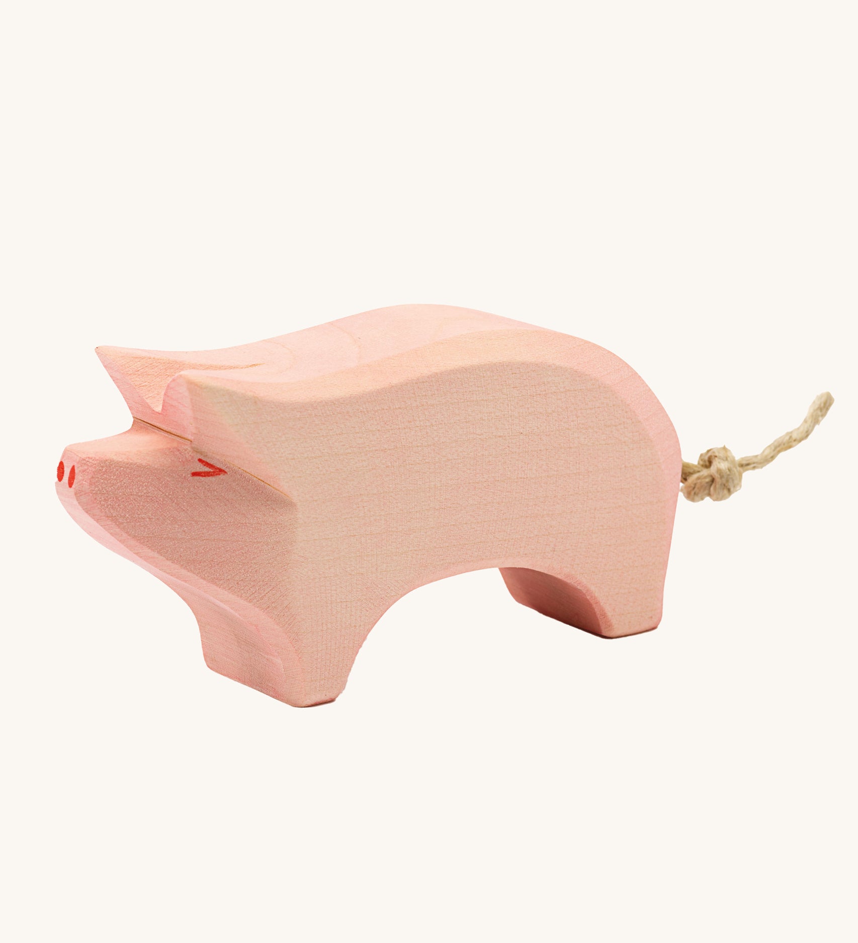 Ostheimer Pig toy figure with it's Head held High on a plain background. 