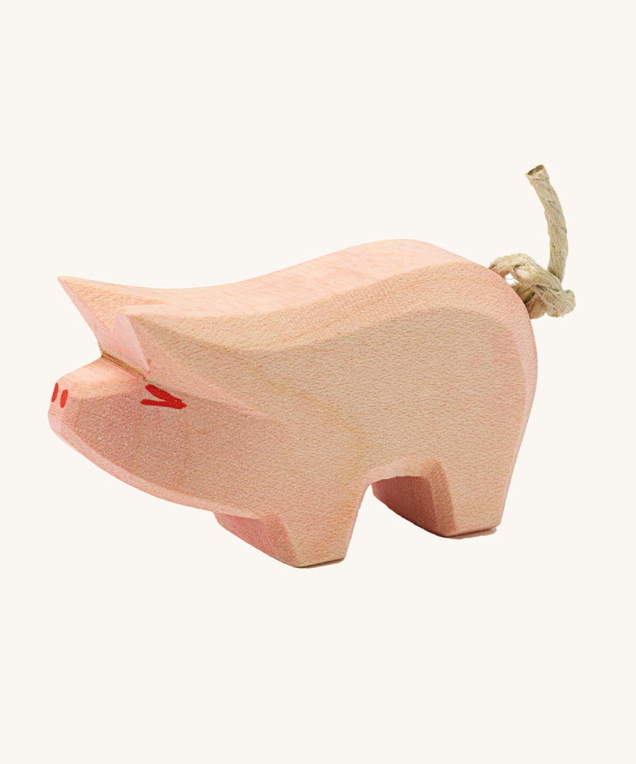 Ostheimer piglet wooden toy figure on a plain background. 