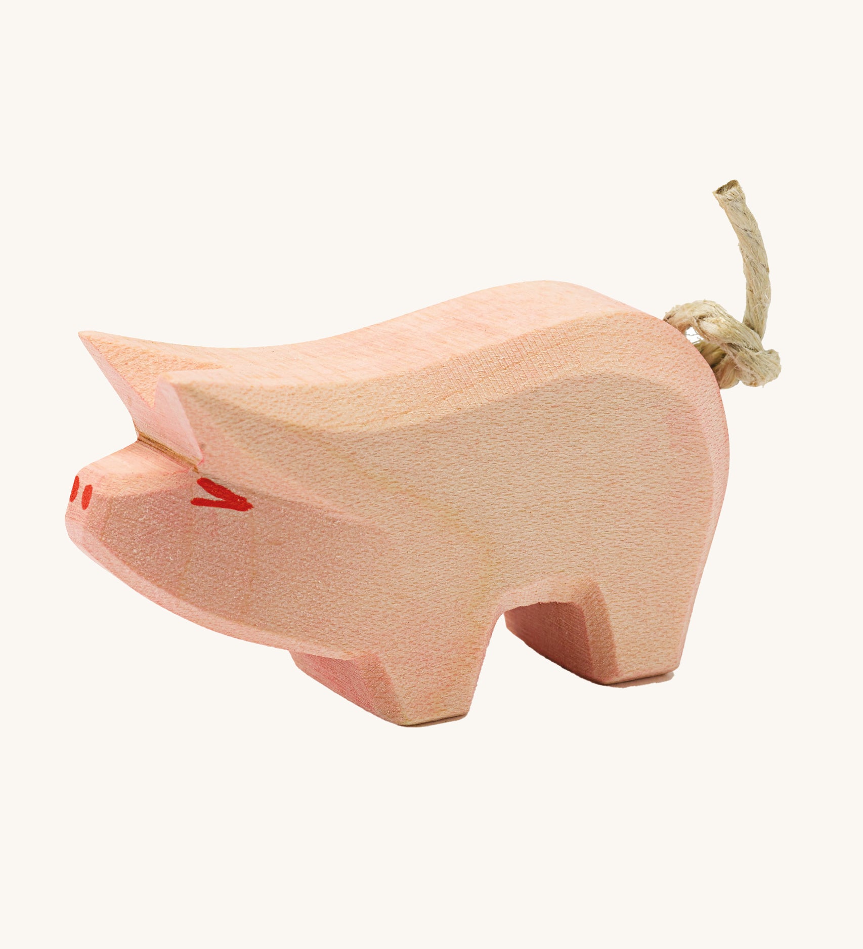 Ostheimer piglet wooden toy figure on a plain background. 