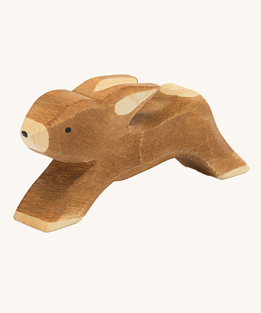 Ostheimer wooden toy running rabbit figure on a plain background. 