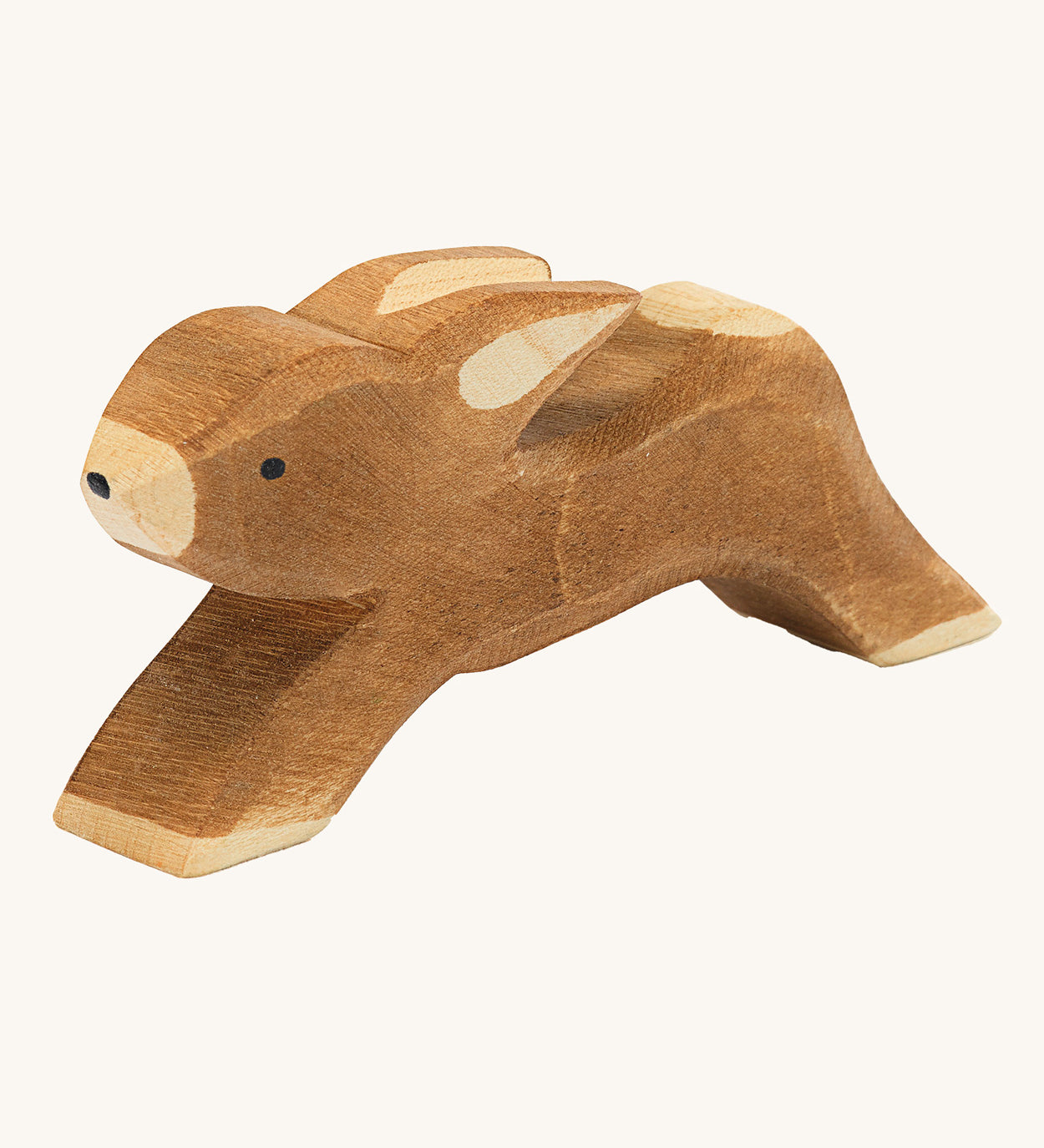 Ostheimer wooden toy running rabbit figure on a cream background. 