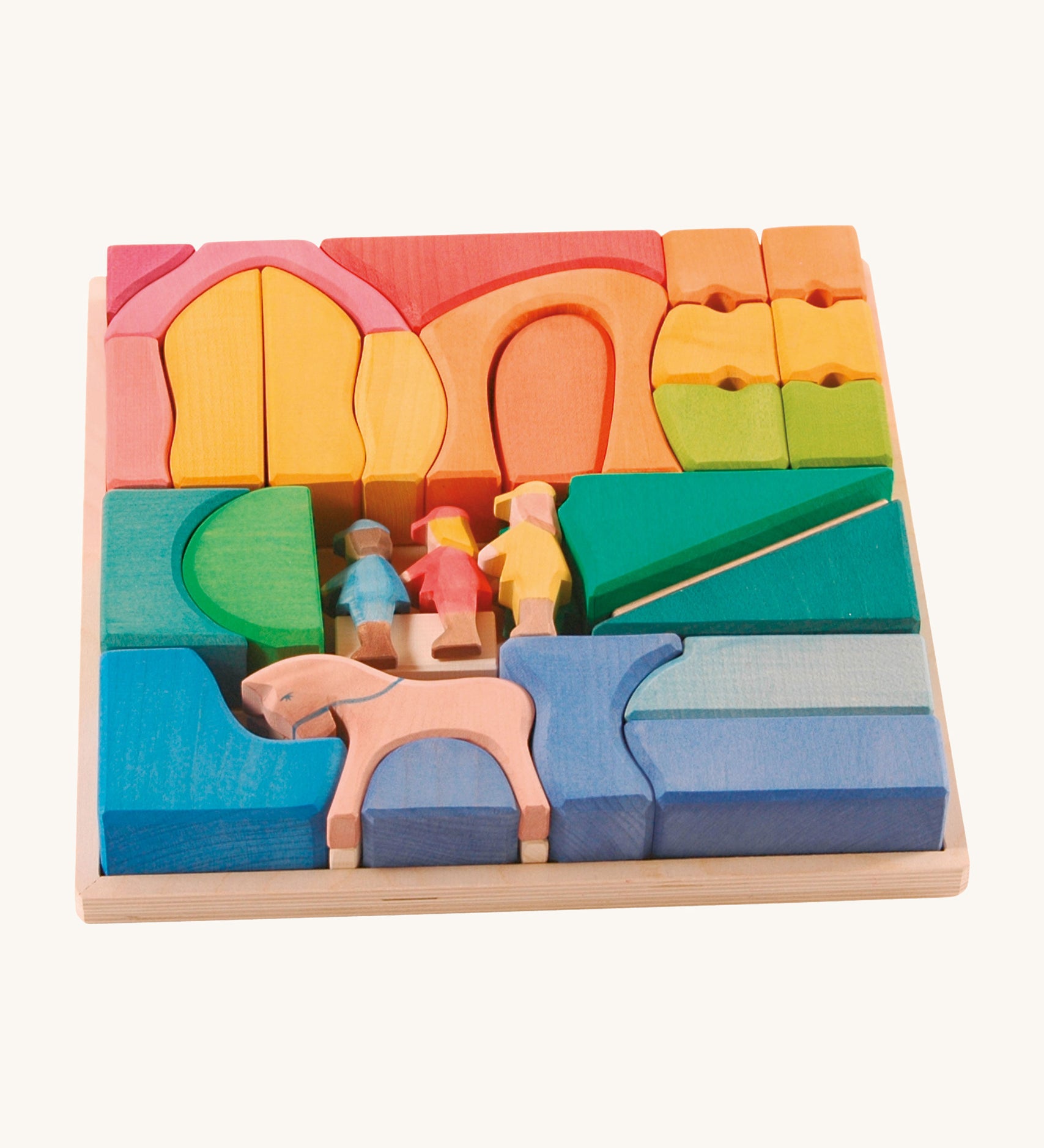 Ostheimer Rainbow Rider Farm wooden toy blocks set on a plain background. The blocks are placed in the wooden tray that they come with. 
