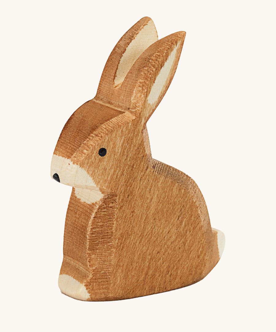 Ostheimer sitting rabbit wooden toy figure on a plain background. 