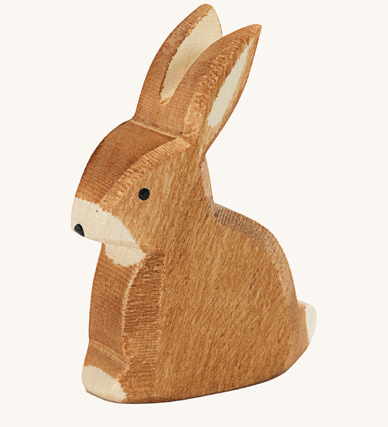 Ostheimer sitting rabbit wooden toy figure on a plain background. 