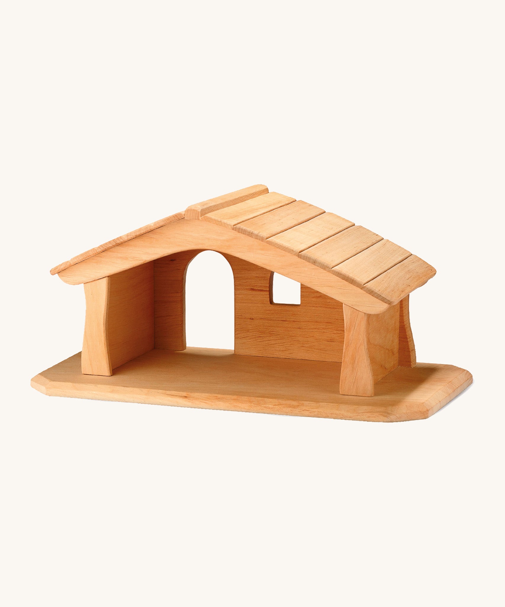 A small wooden Ostheimer stable on a cream background.