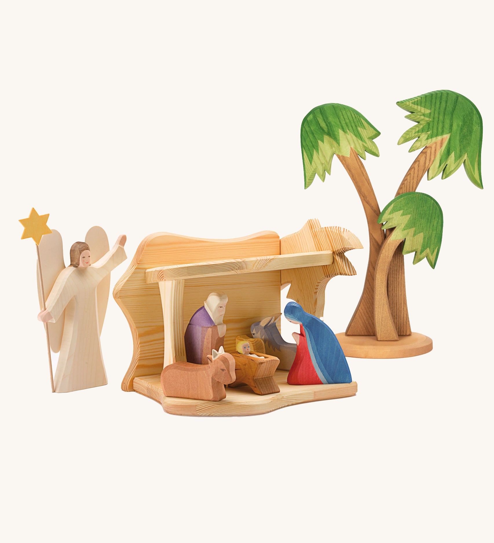 Ostheimer small wooden toy stable on a plain background. The stable has been filled and surrounded by Ostheimer nativity themed figures. 