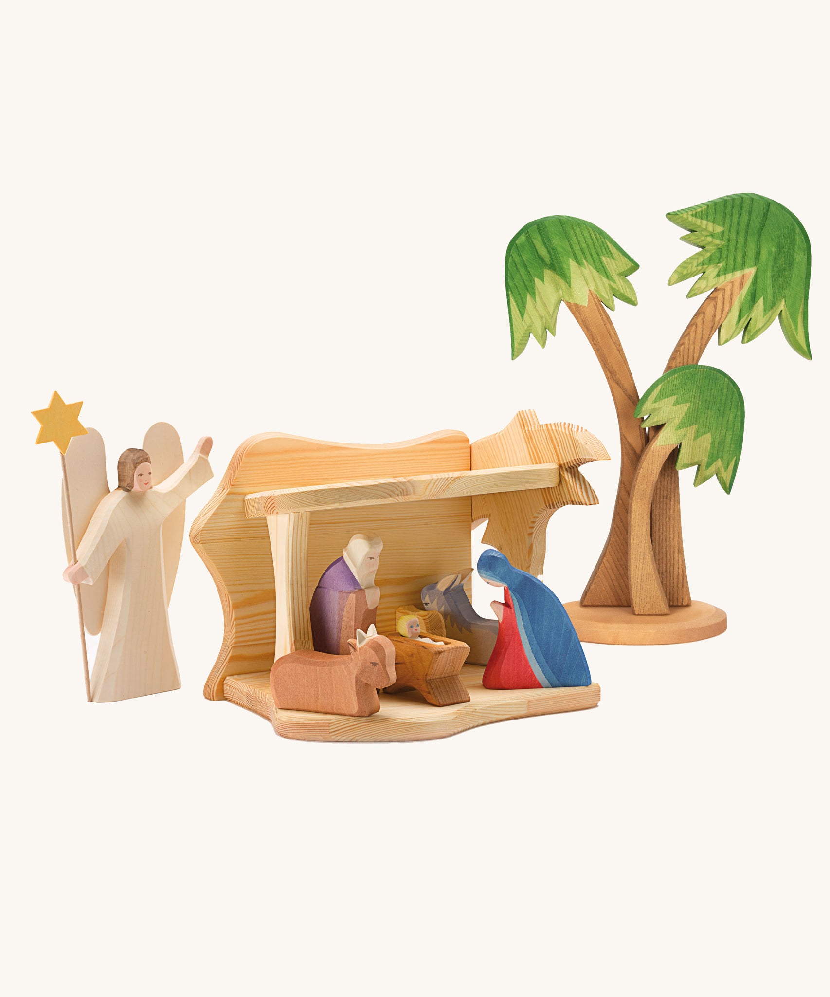 Ostheimer small wooden toy stable on a plain background. The stable has been filled and surrounded by Ostheimer nativity themed figures. 