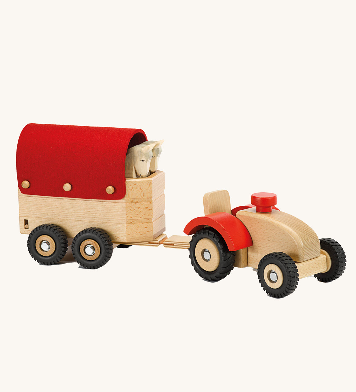 Ostheimer Wooden Tractor toy attached to a sock trailer on a plain background. 