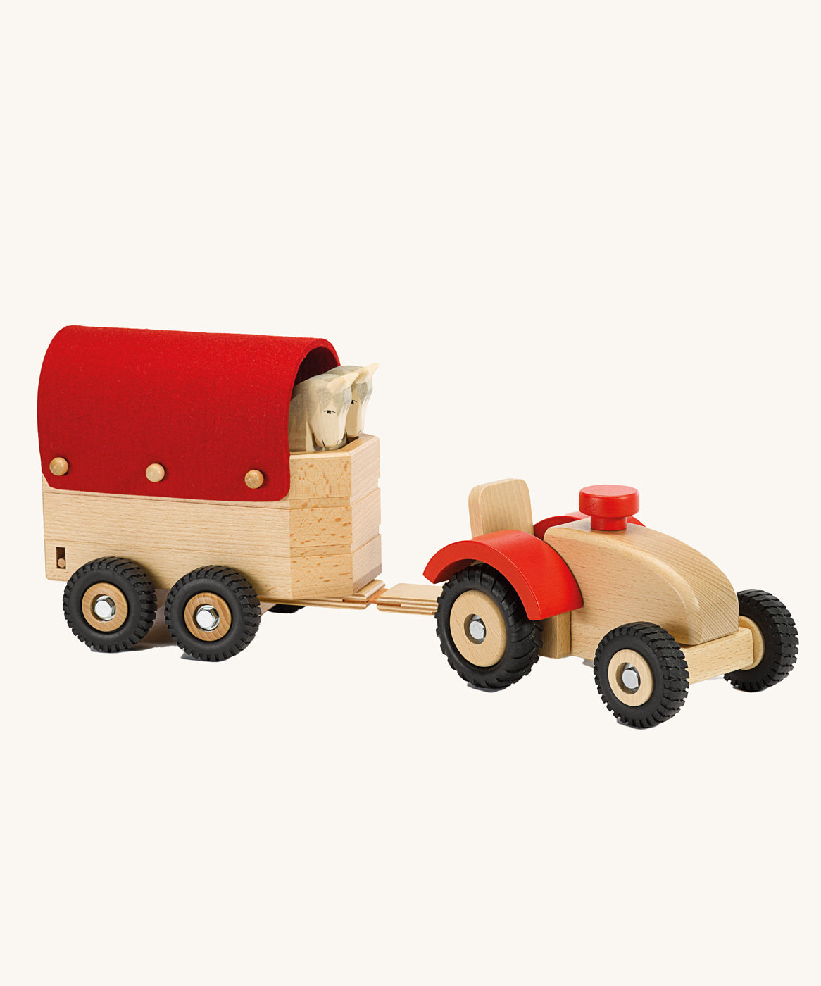 Ostheimer Wooden Tractor toy attached to a sock trailer on a plain background. 