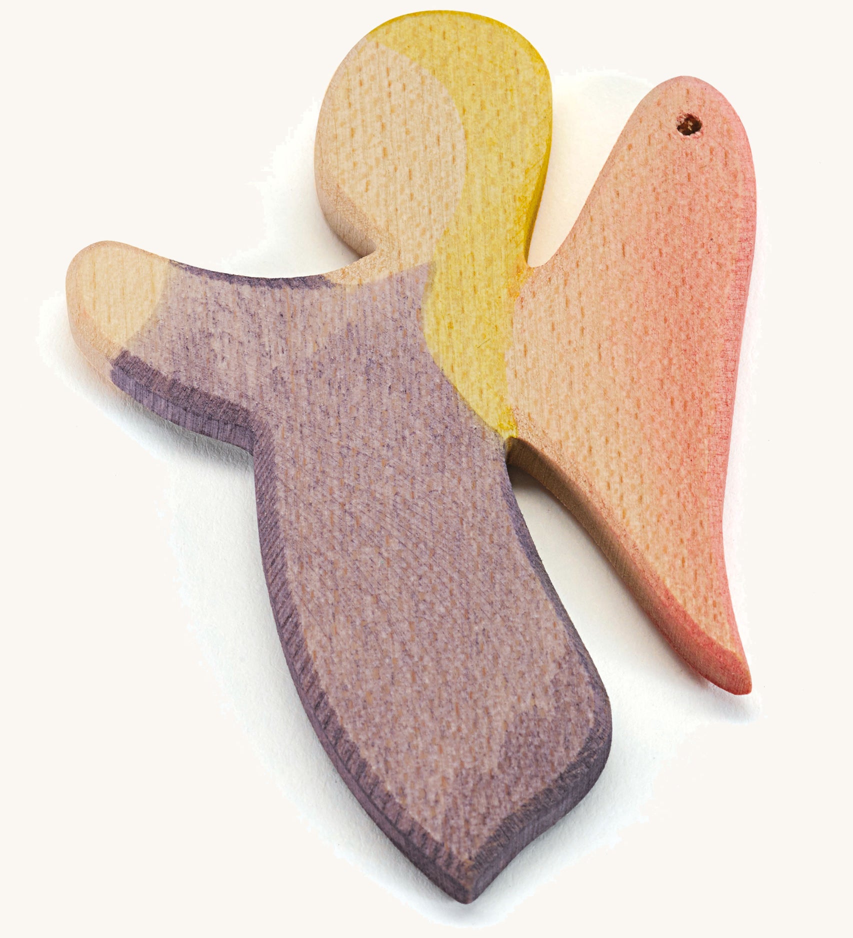 A wooden violet angel figure on a cream background