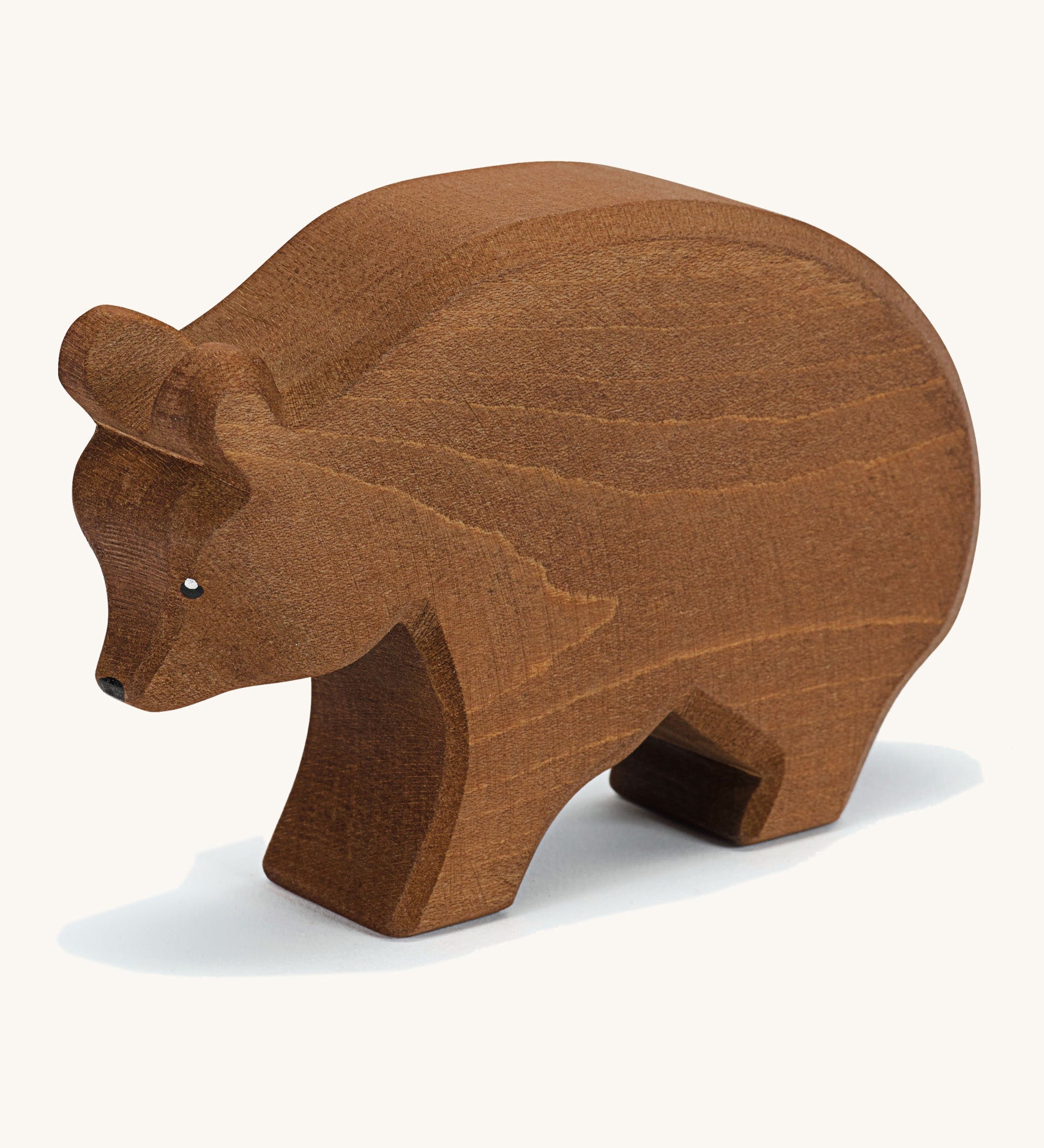 A wooden Ostheimer brown bear figure on a cream background