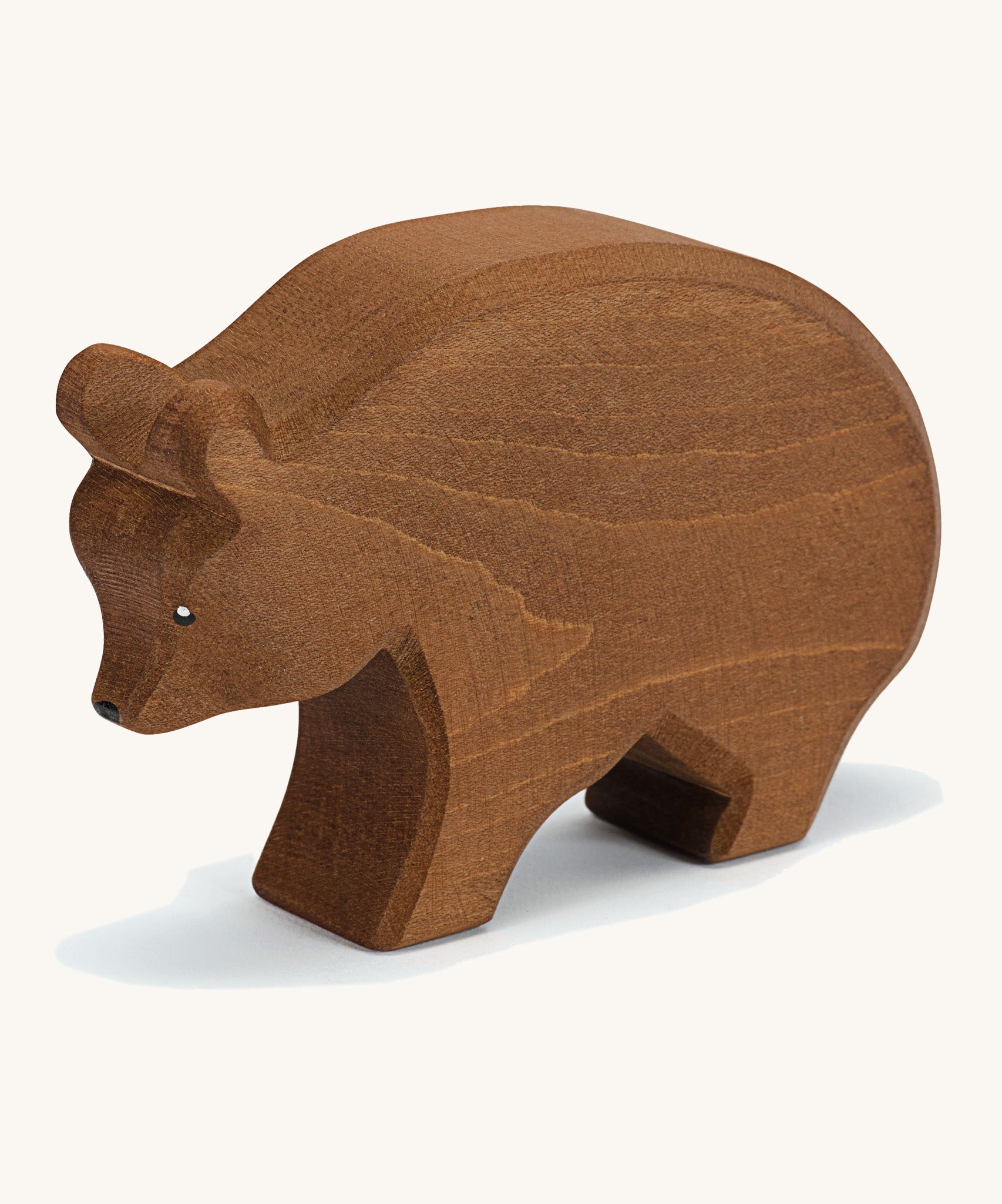 A wooden Ostheimer brown bear figure on a cream background