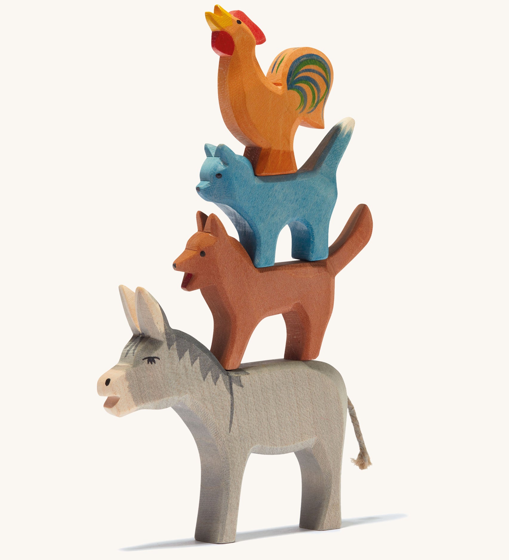 Ostheimer Town Musicians of Bremer, 4 wooden animal toy set stacked on top of each other on a cream background