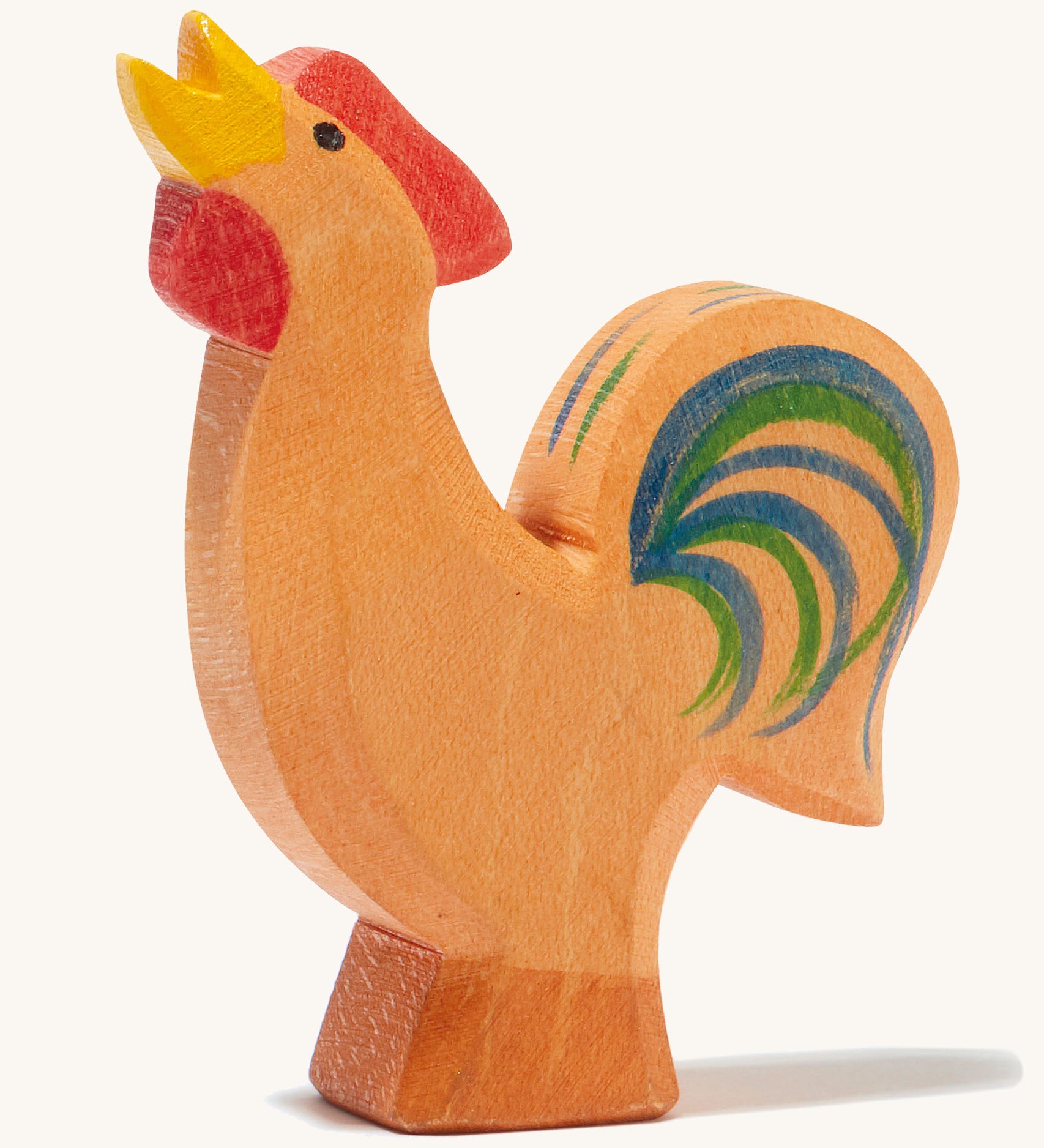 A brown wooden Ostheimer bremer rooster on a cream background.