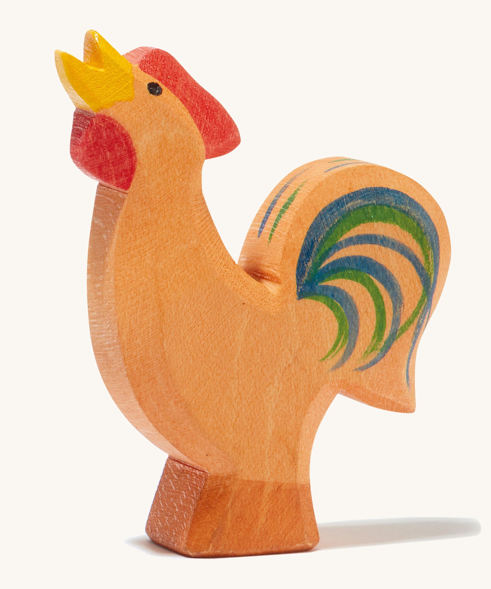 A brown wooden Ostheimer bremer rooster on a cream background.