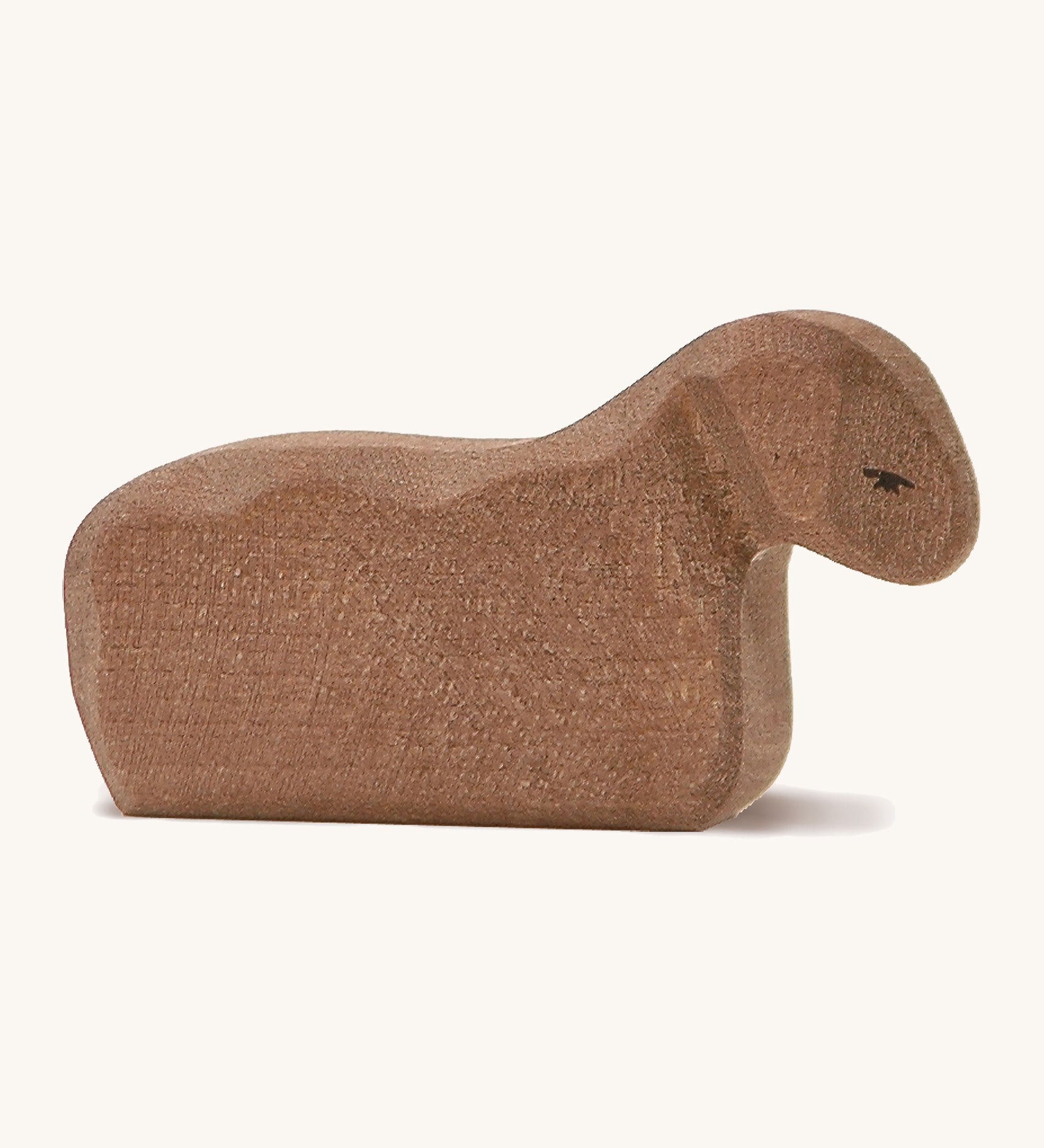 A brown wooden Ostheimer resting lamb on a cream background.