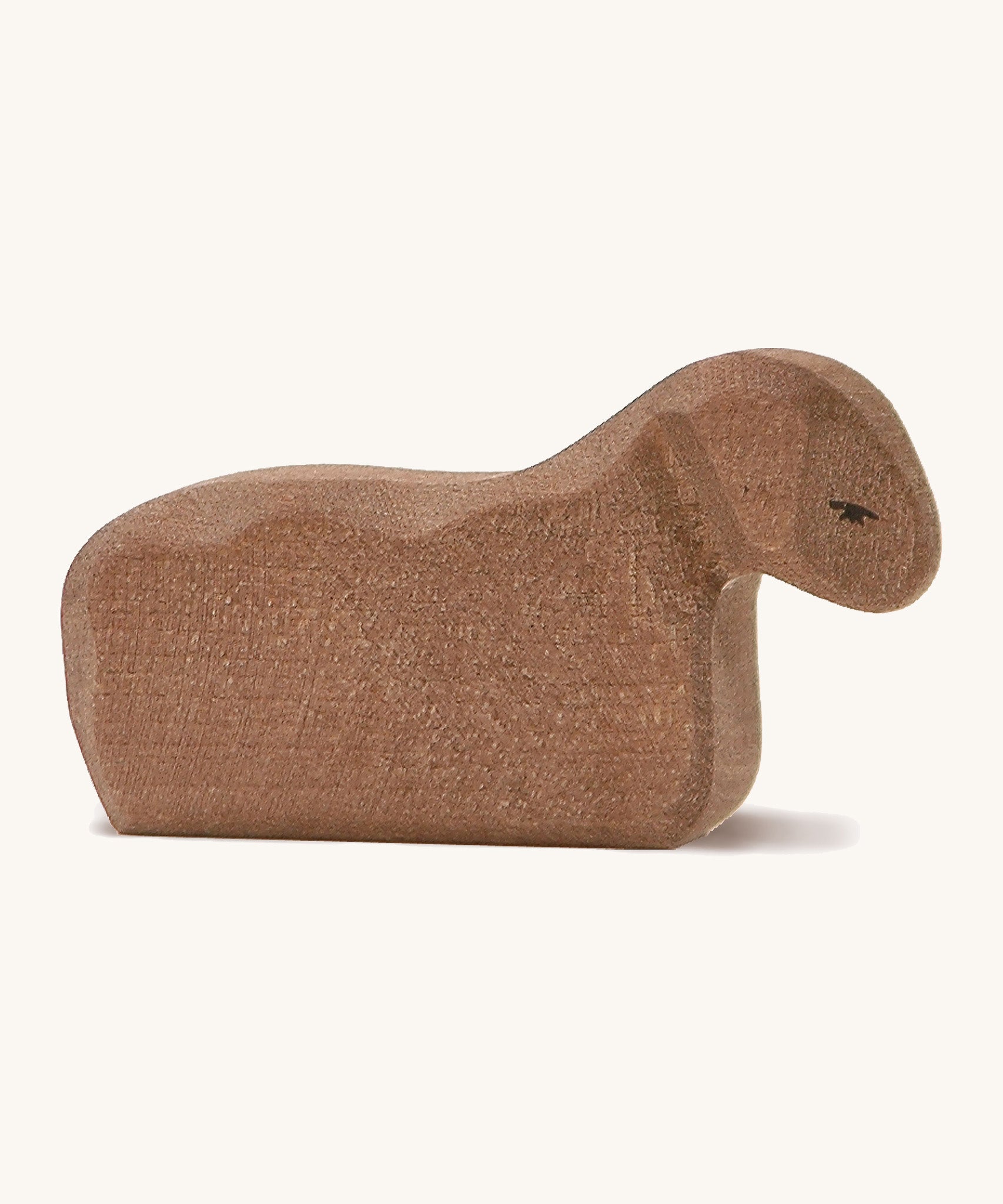 A brown wooden Ostheimer resting lamb on a cream background.