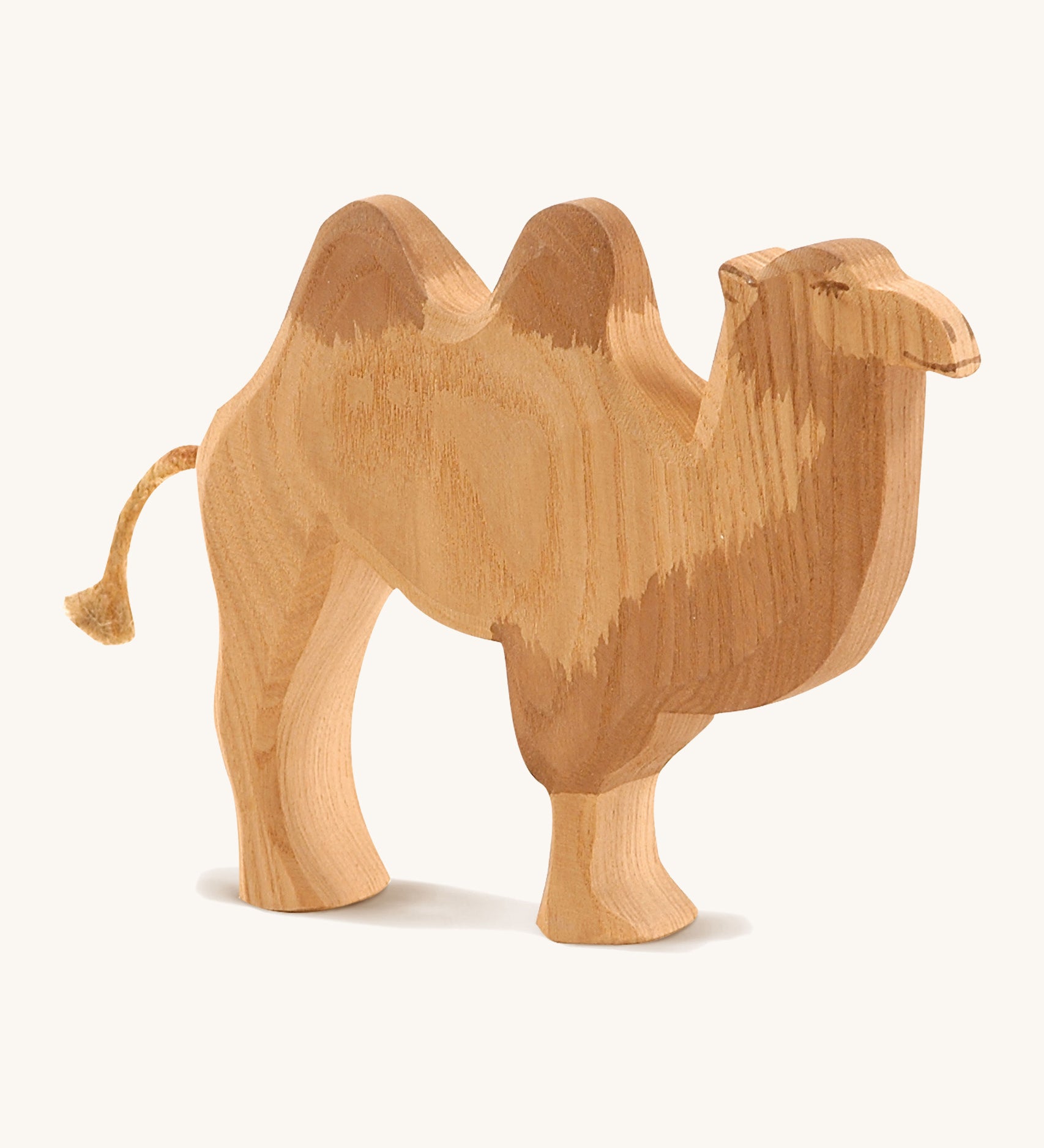 A wooden Ostheimer camel figure on a cream background.