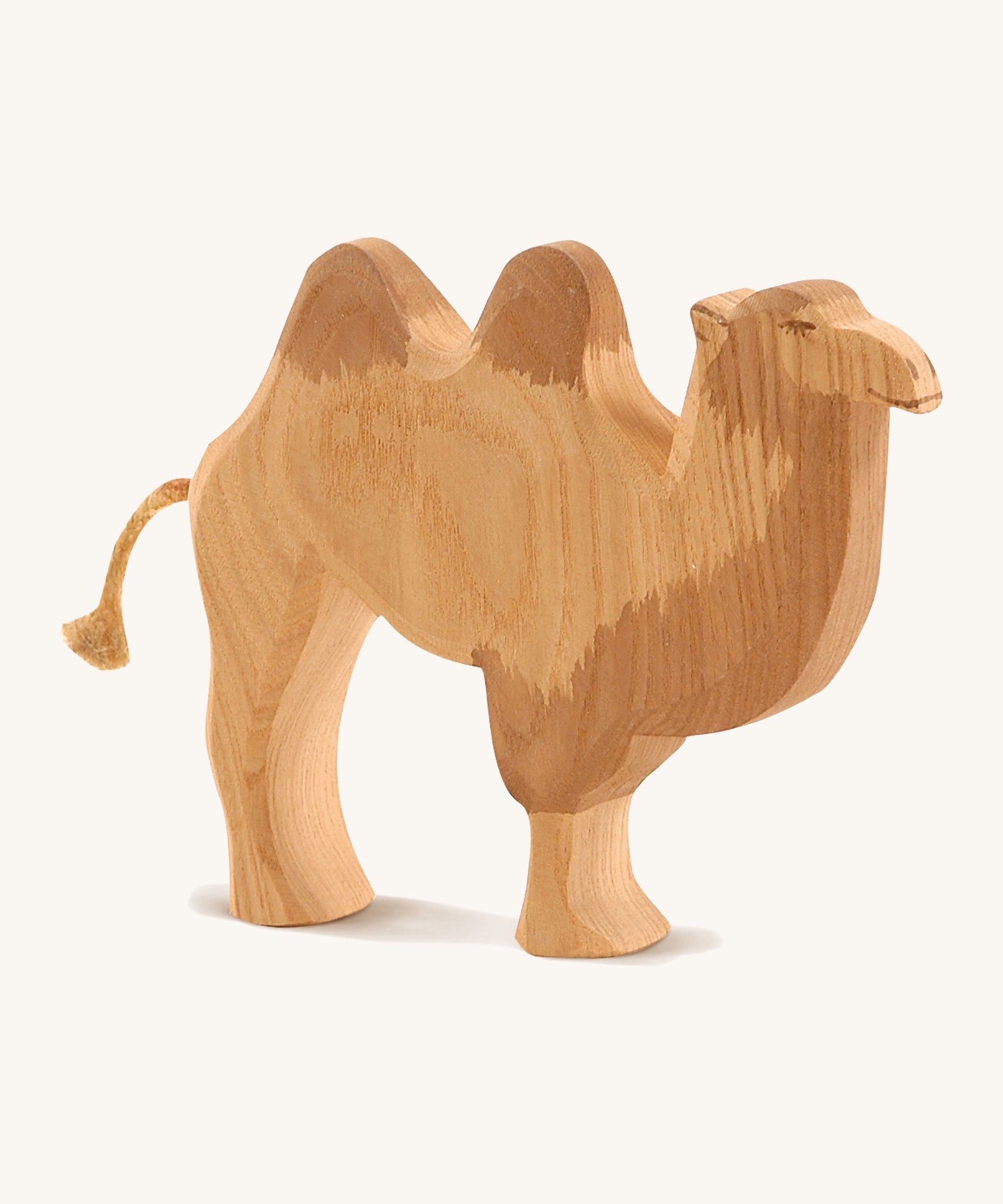 A wooden Ostheimer camel figure on a cream background.