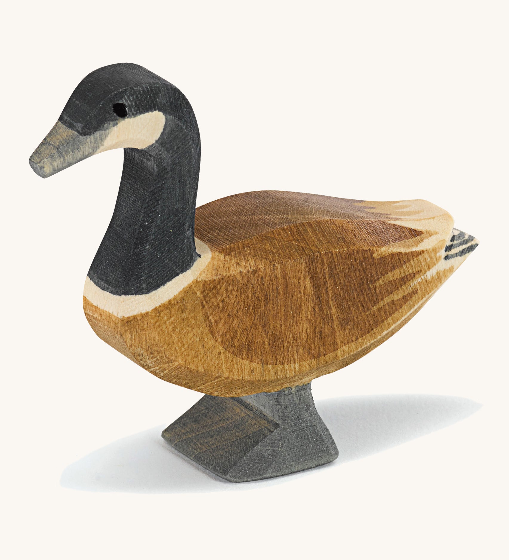 A wooden standing Ostheimer Canadian goose on a cream background.