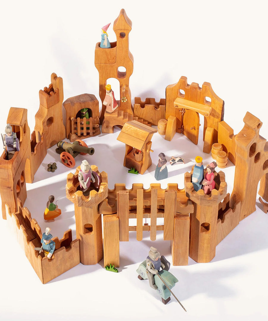 Ostheimer children's wooden castle set laid out on a beige background