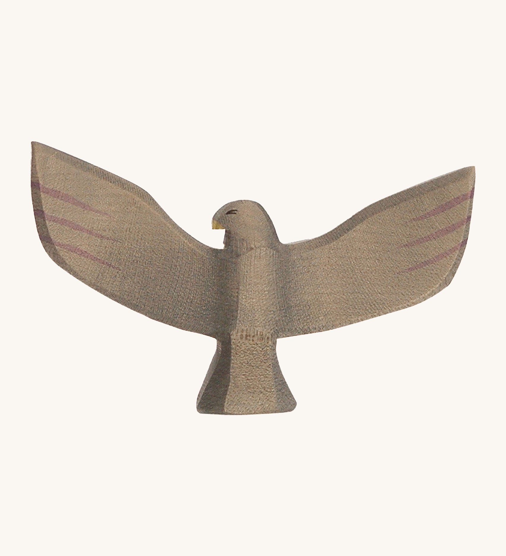 A wooden brown Ostheimer eagle with its wings spread out on a cream background. 