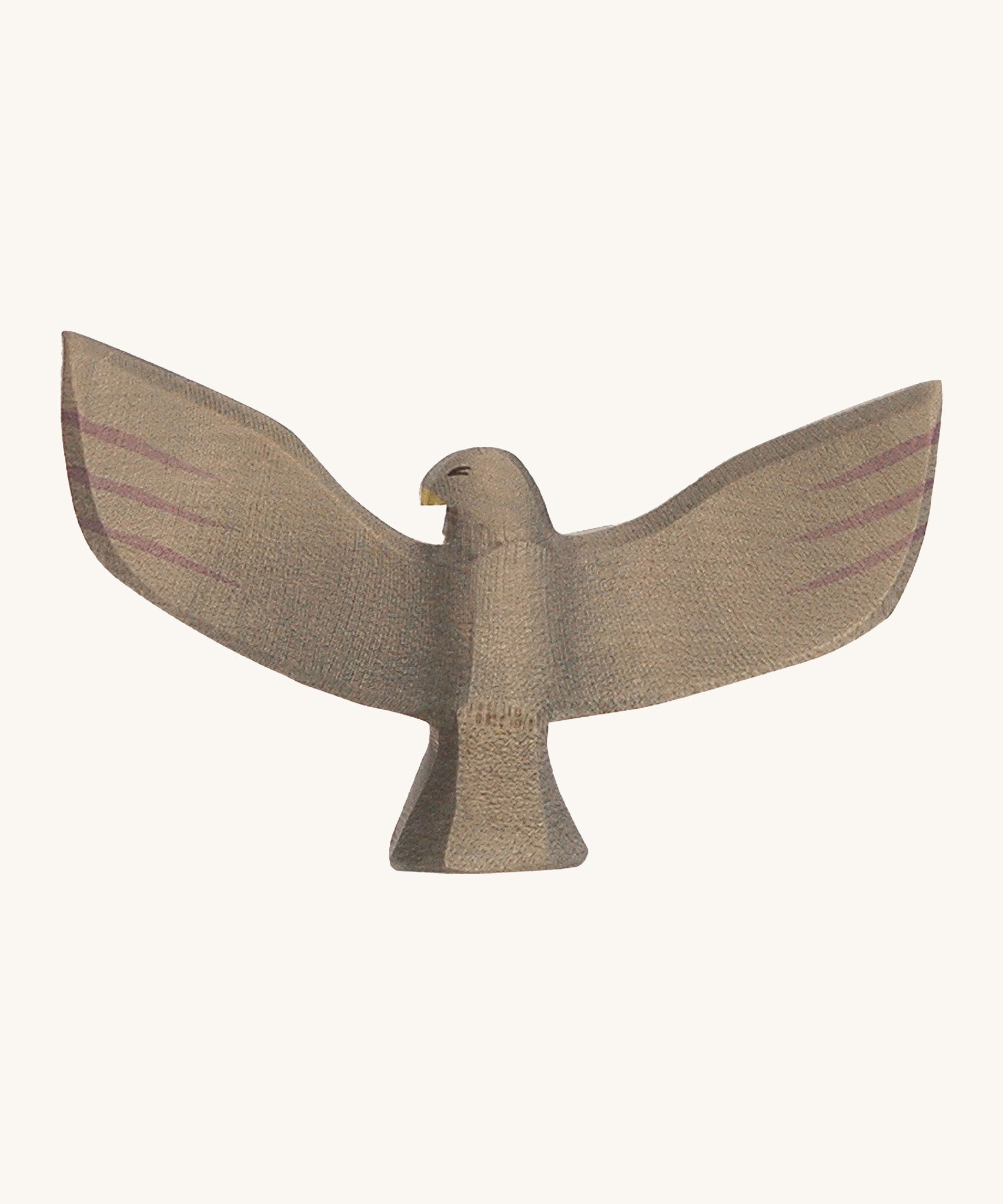 A wooden brown Ostheimer eagle with its wings spread out on a cream background. 