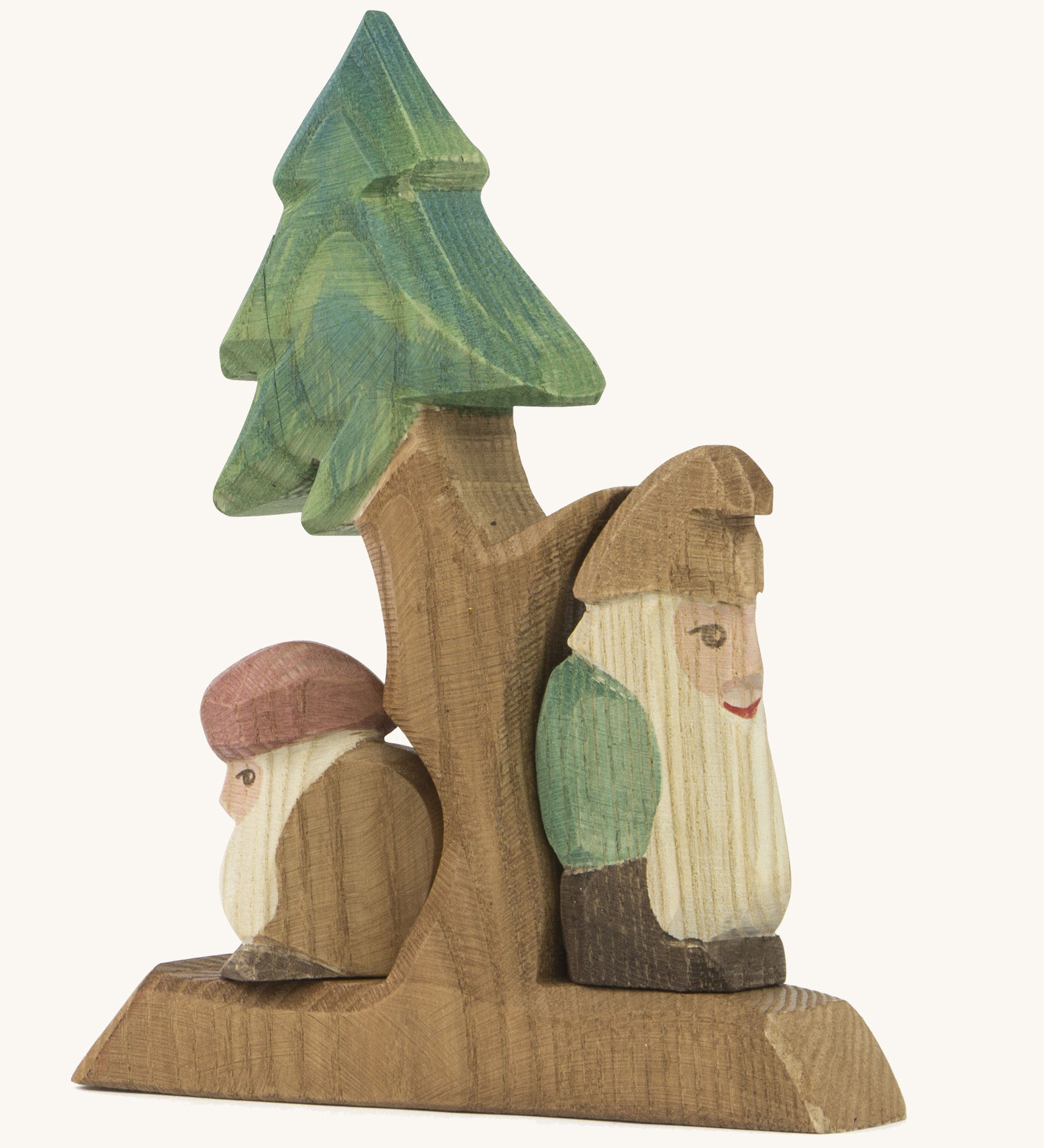 A wooden fir Ostheimer tree with the sitting and standing Ostheimer fir tree dwarves on the stand on a cream background.