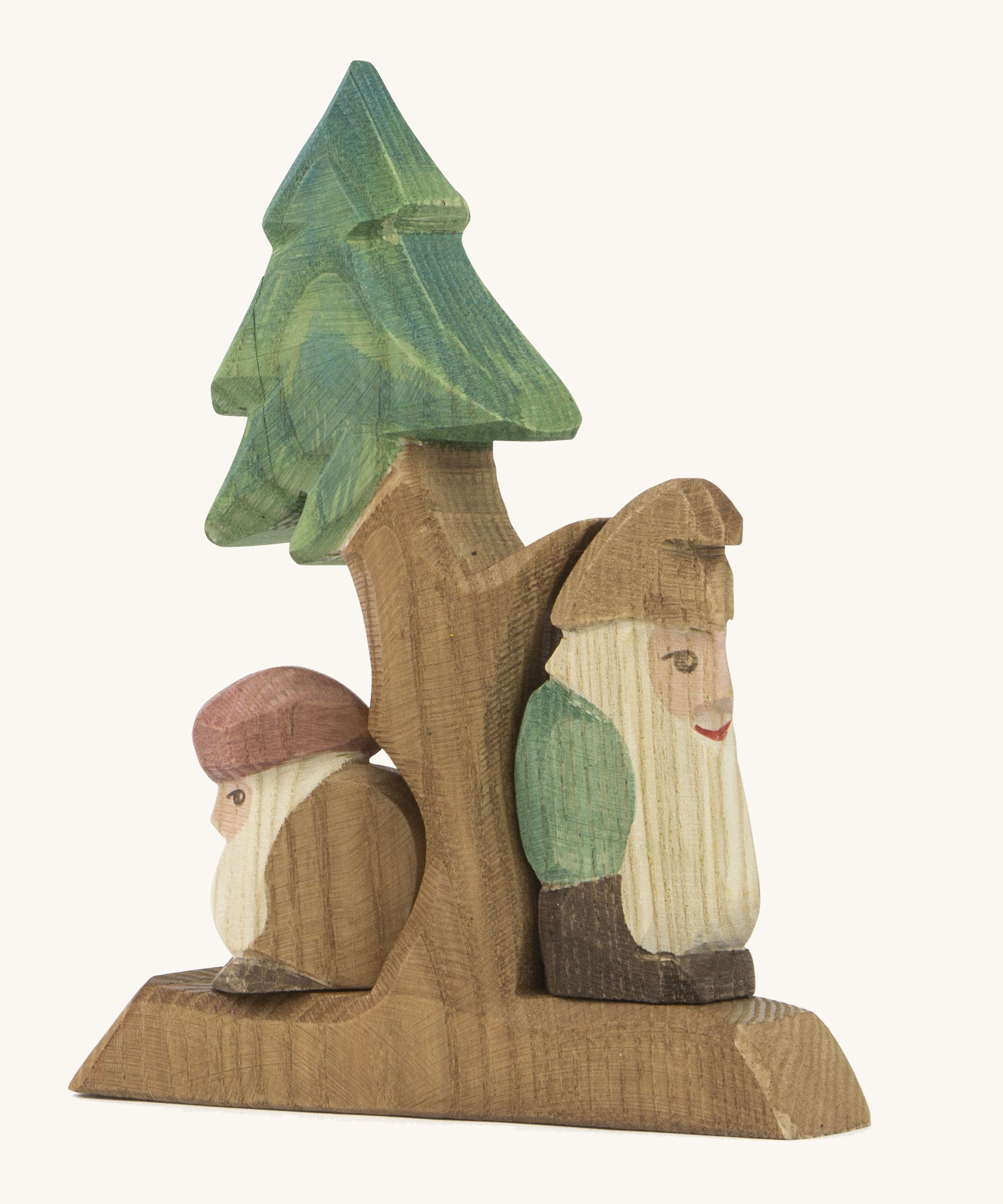 A wooden fir Ostheimer tree with the sitting and standing Ostheimer fir tree dwarves on the stand on a cream background.