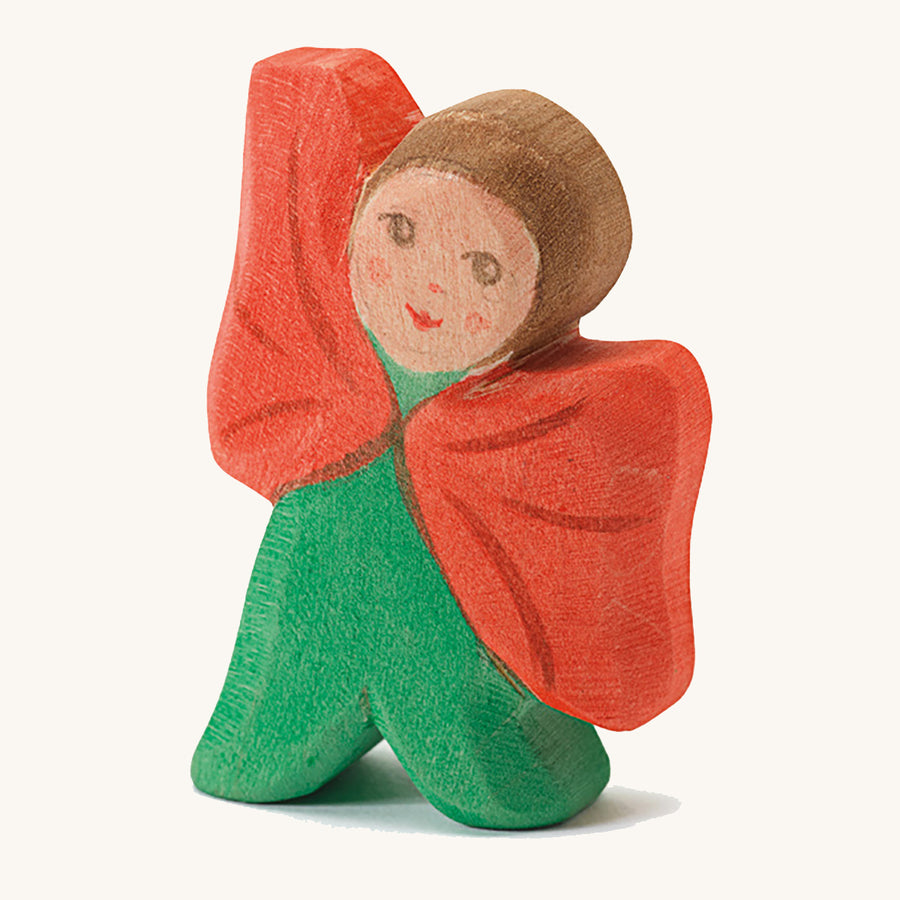 Ostheimer Wooden Toy Flower Child - Poppy. A beautifully hand crafted and hand painted Ostheimer Flower Child in a green outfit with a red cape, on a cream background