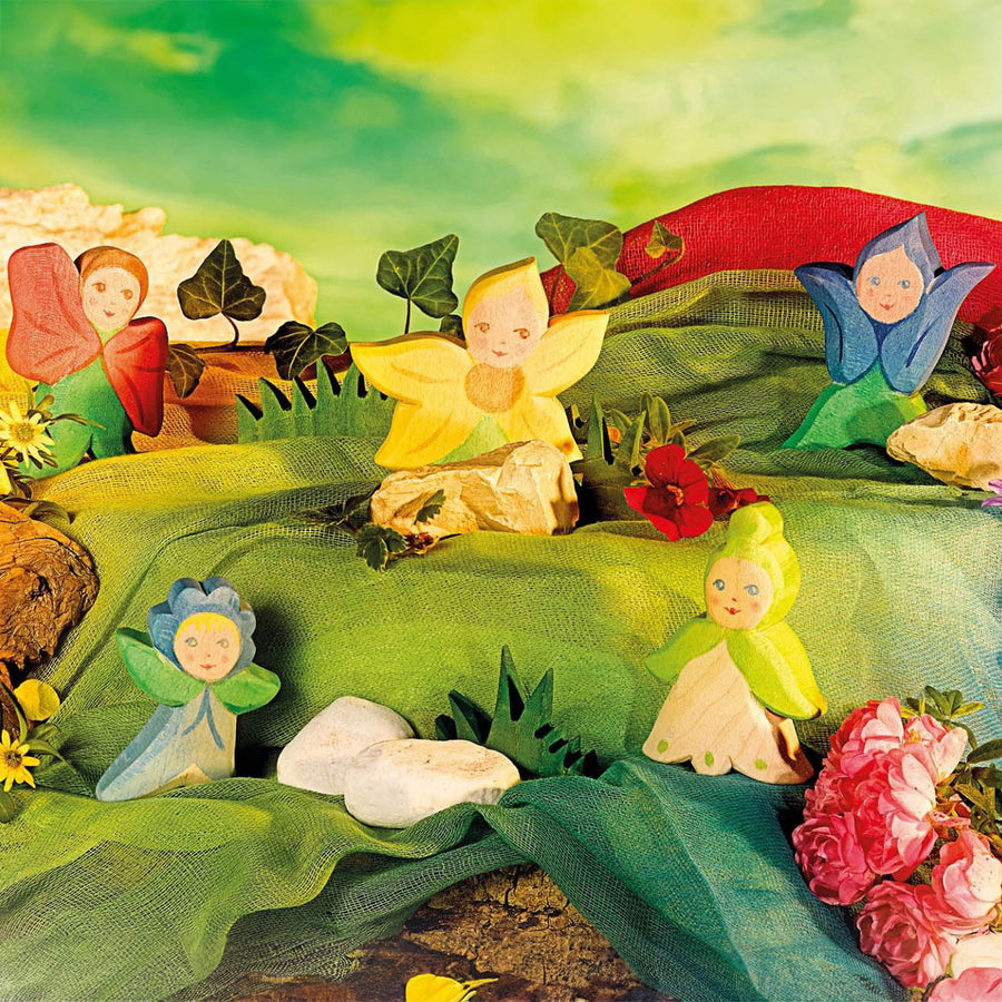 The Ostheimer Wooden Flower Children all playing together in a Fairytale fantasy play scene. All of the Ostheimer Wooden Flower Children are handmade and hand crafted from natural wood