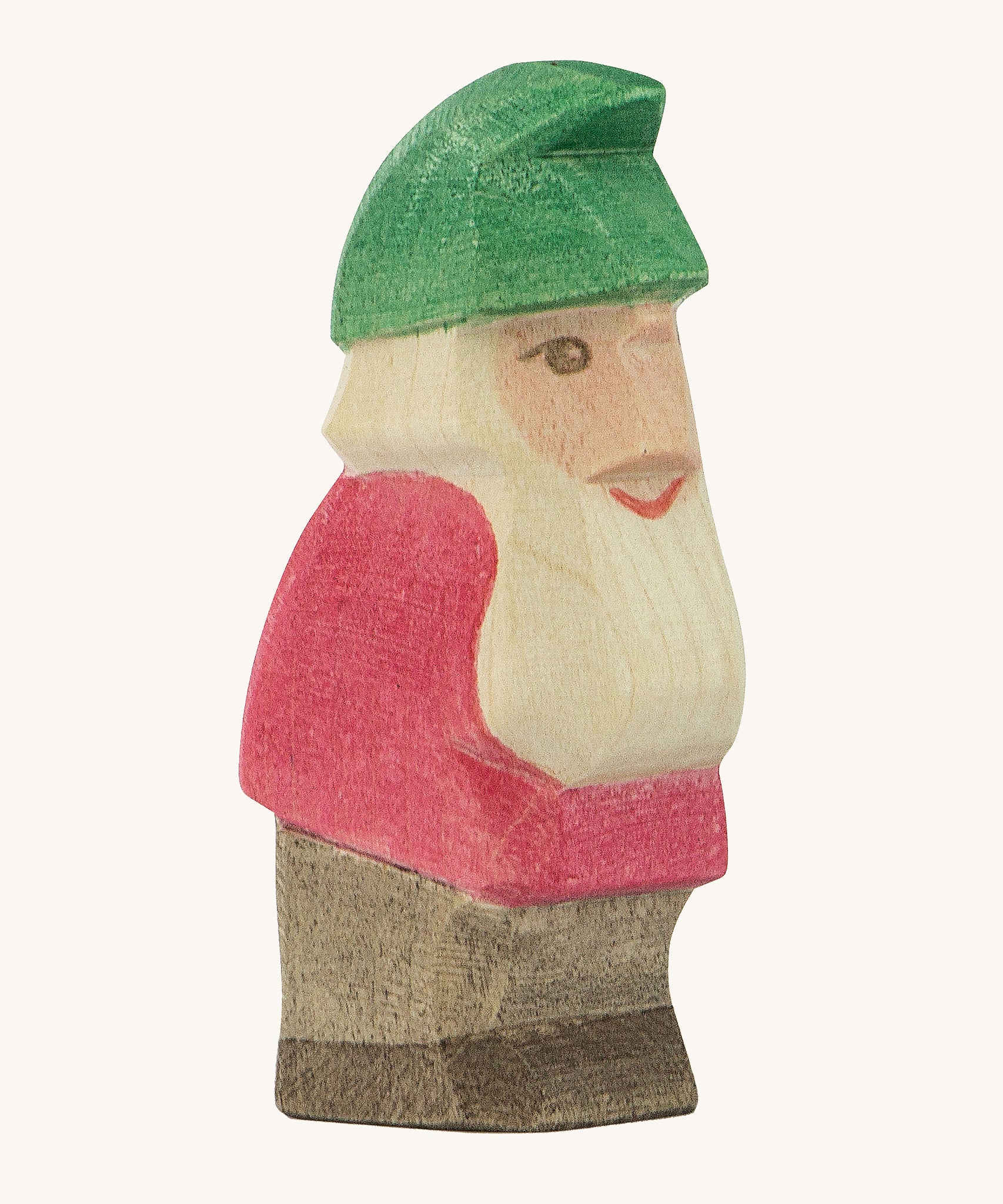 A wooden Ostheimer Fridolin dwarf figure wearing a red top, brown trousers and a green hat on a cream background.