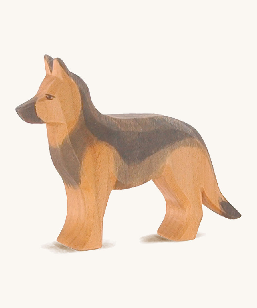 A wooden Ostheimer German shepherd dog on a cream background.