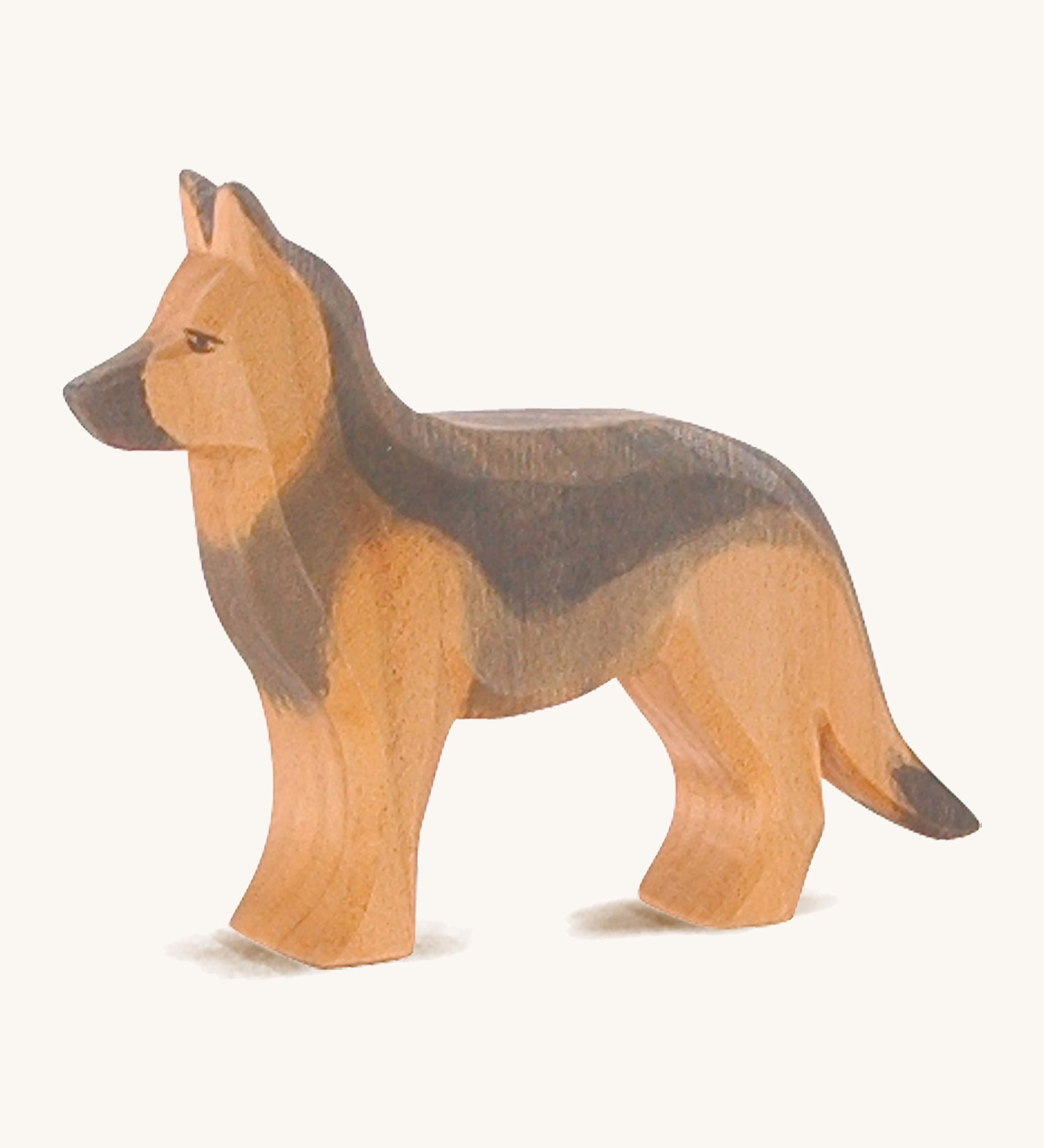 A wooden Ostheimer German shepherd dog on a cream background.