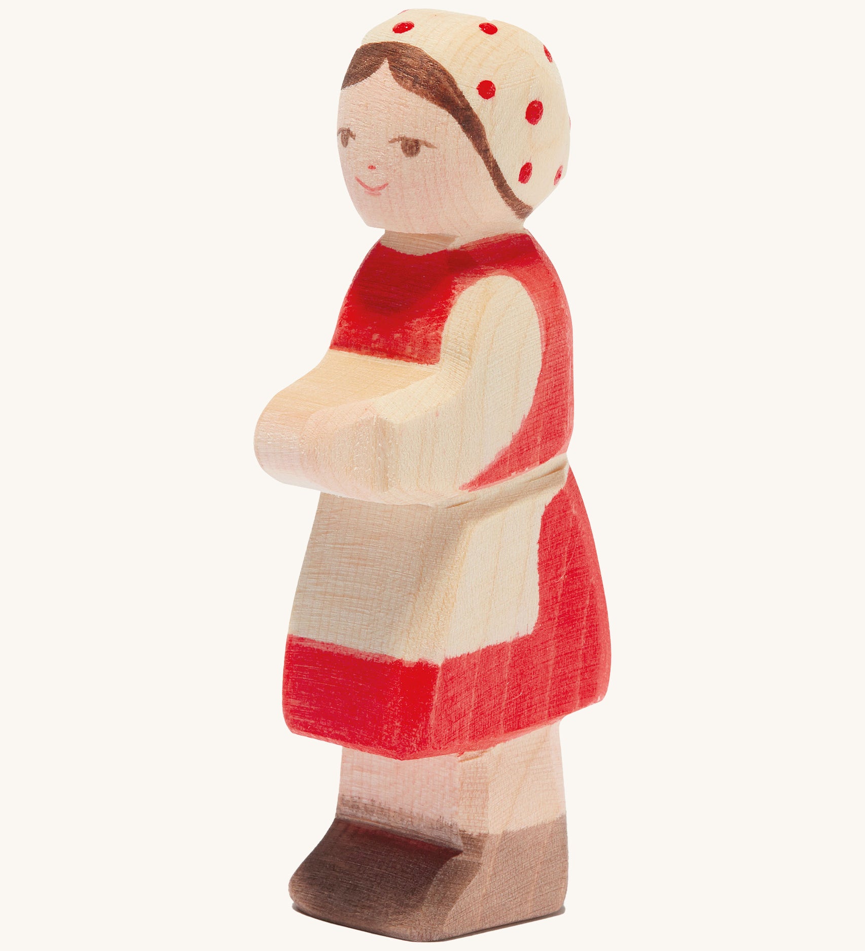 Ostheimer wooden farm girl with red dress and red spotted head scarf on a cream background