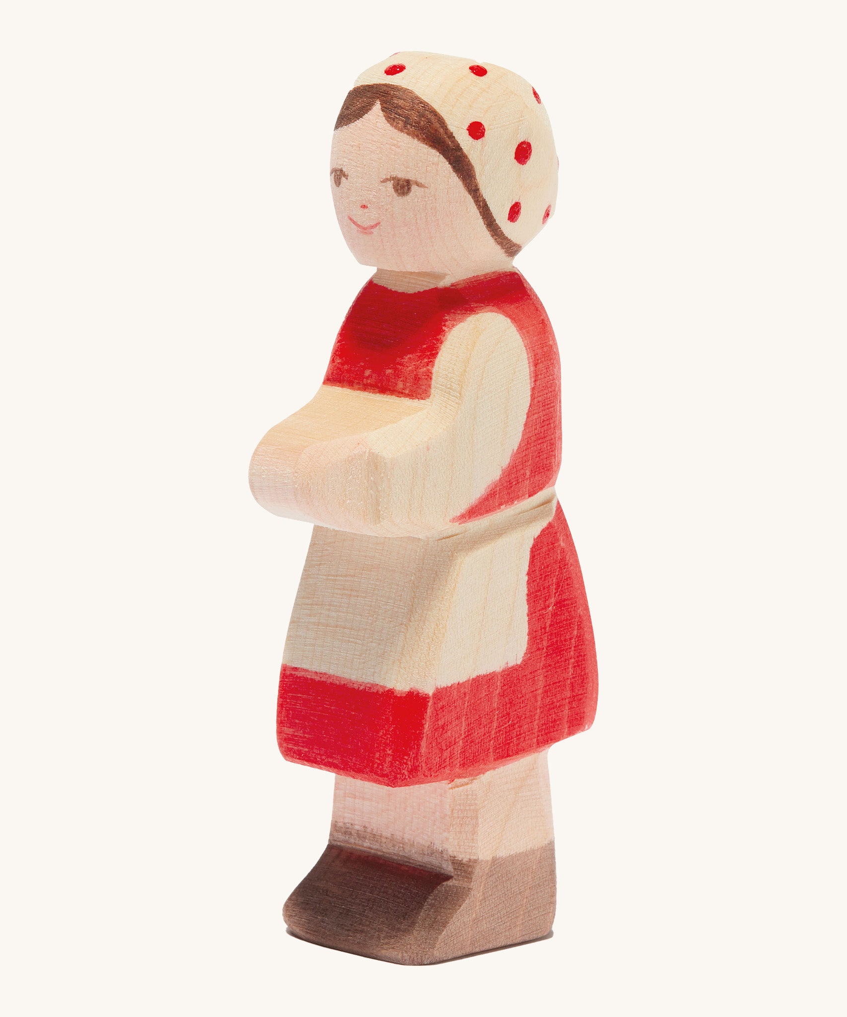 Ostheimer wooden farm girl with red dress and red spotted head scarf on a cream background