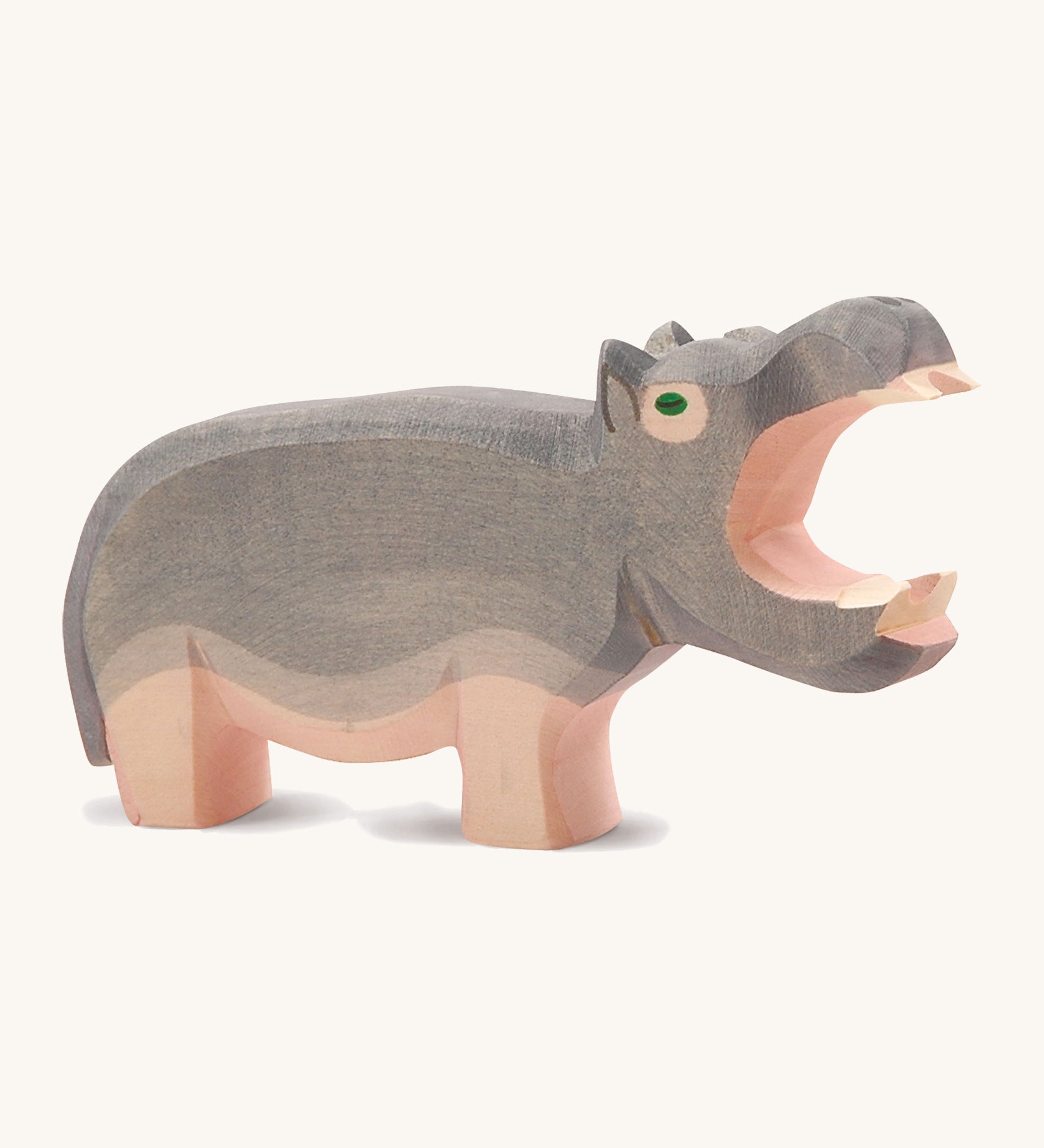 A large wooden Ostheimer hippo figure with its mouth open on a cream background.