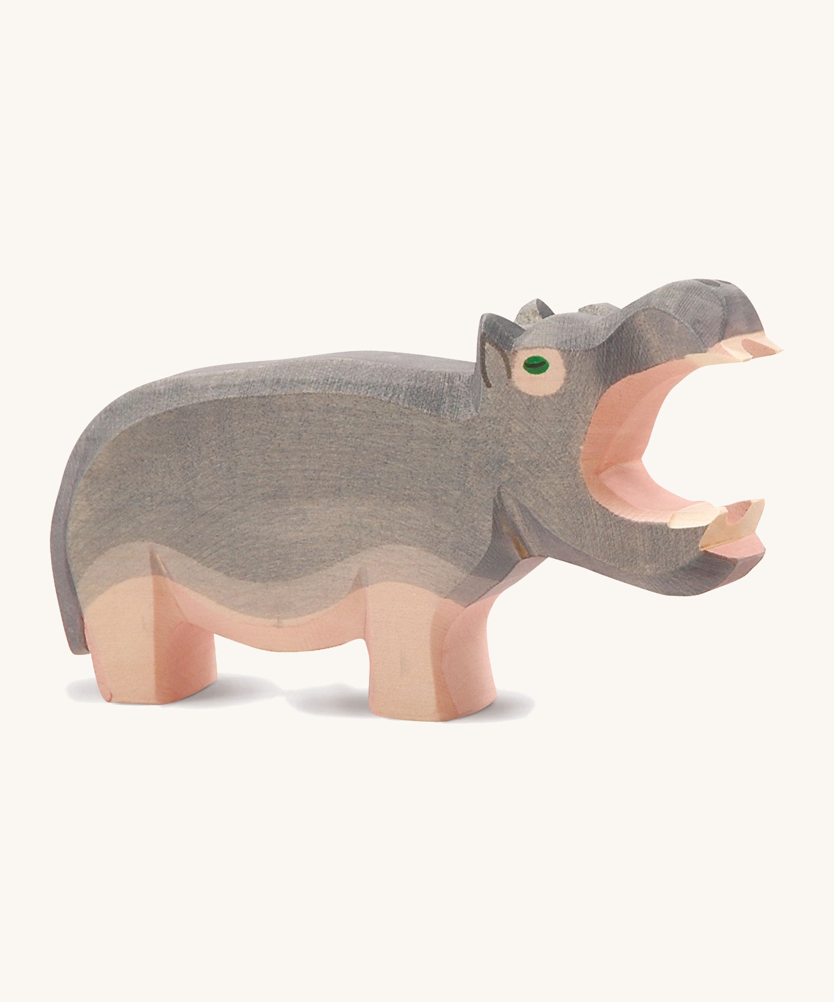 A large wooden Ostheimer hippo figure with its mouth open on a cream background.