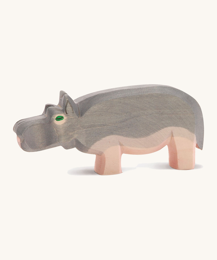 A wooden Ostheimer hippo figure on a cream background.