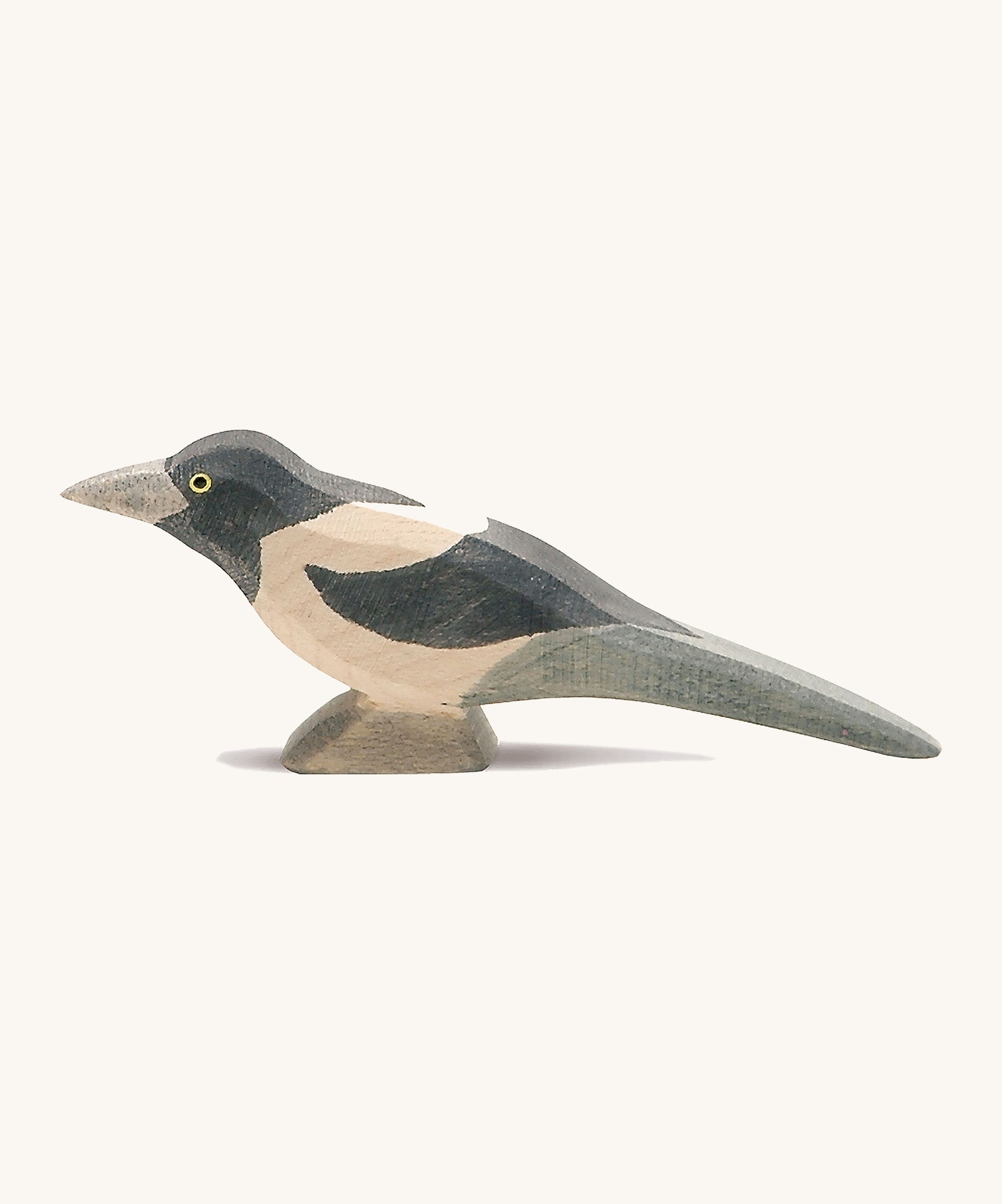 A wooden Ostheimer magpie figure on a cream background.