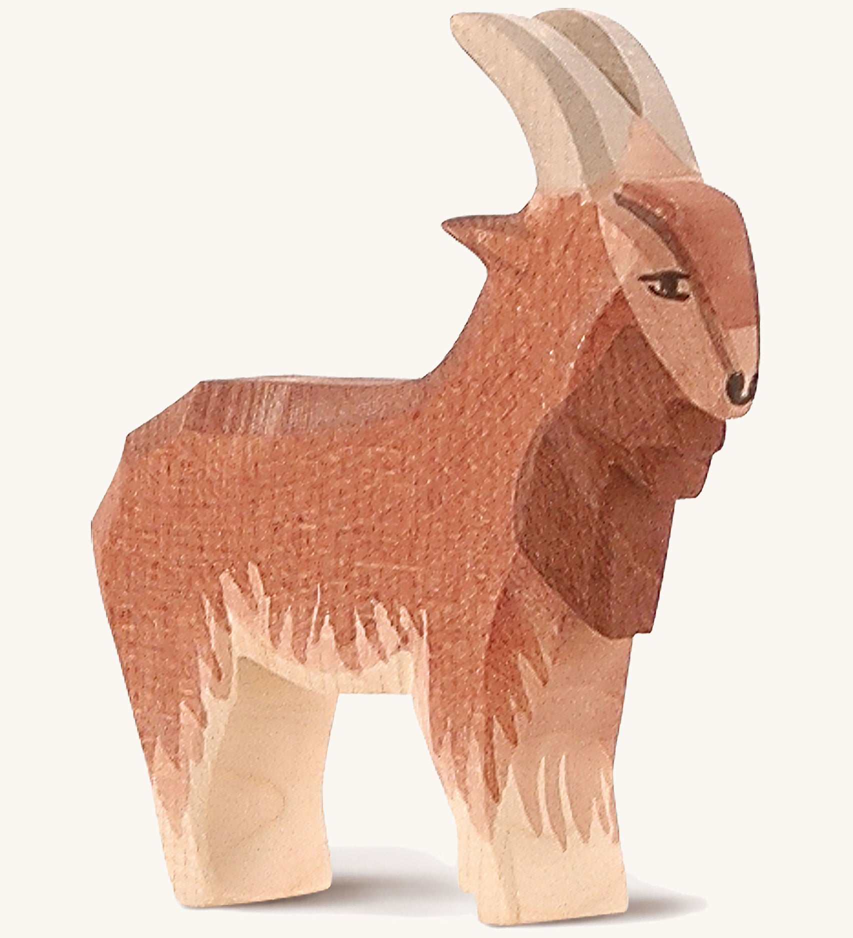 A brown wooden male goat Ostheimer figure on a cream background.