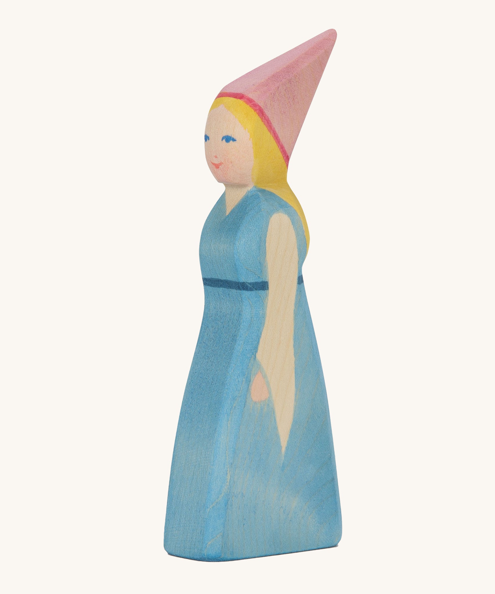 Ostheimer wooden princess with pink head piece and blue dress on a cream background