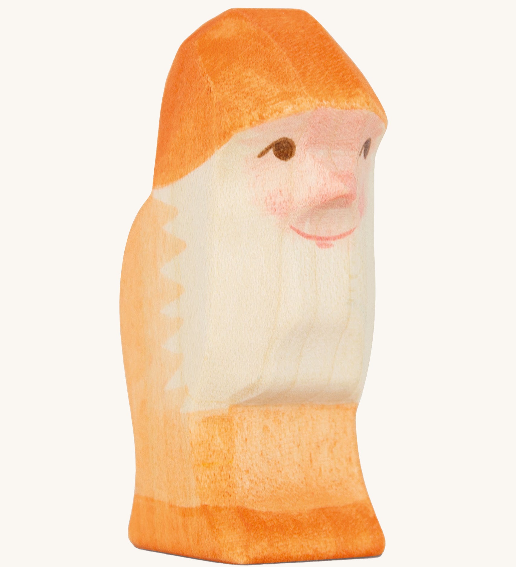 A orange wooden Ostheimer dwarf figure on a cream background.