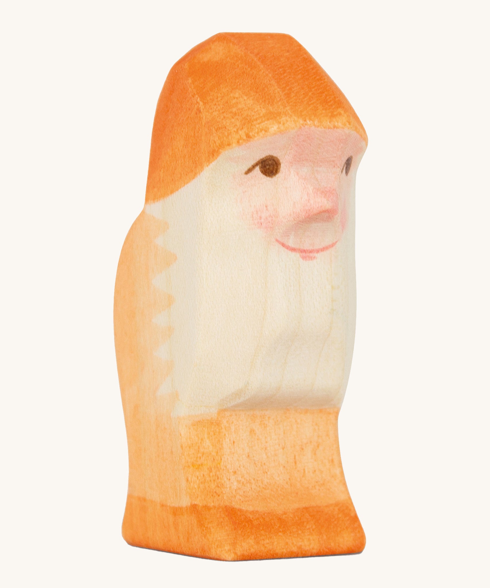 A orange wooden Ostheimer dwarf figure on a cream background.