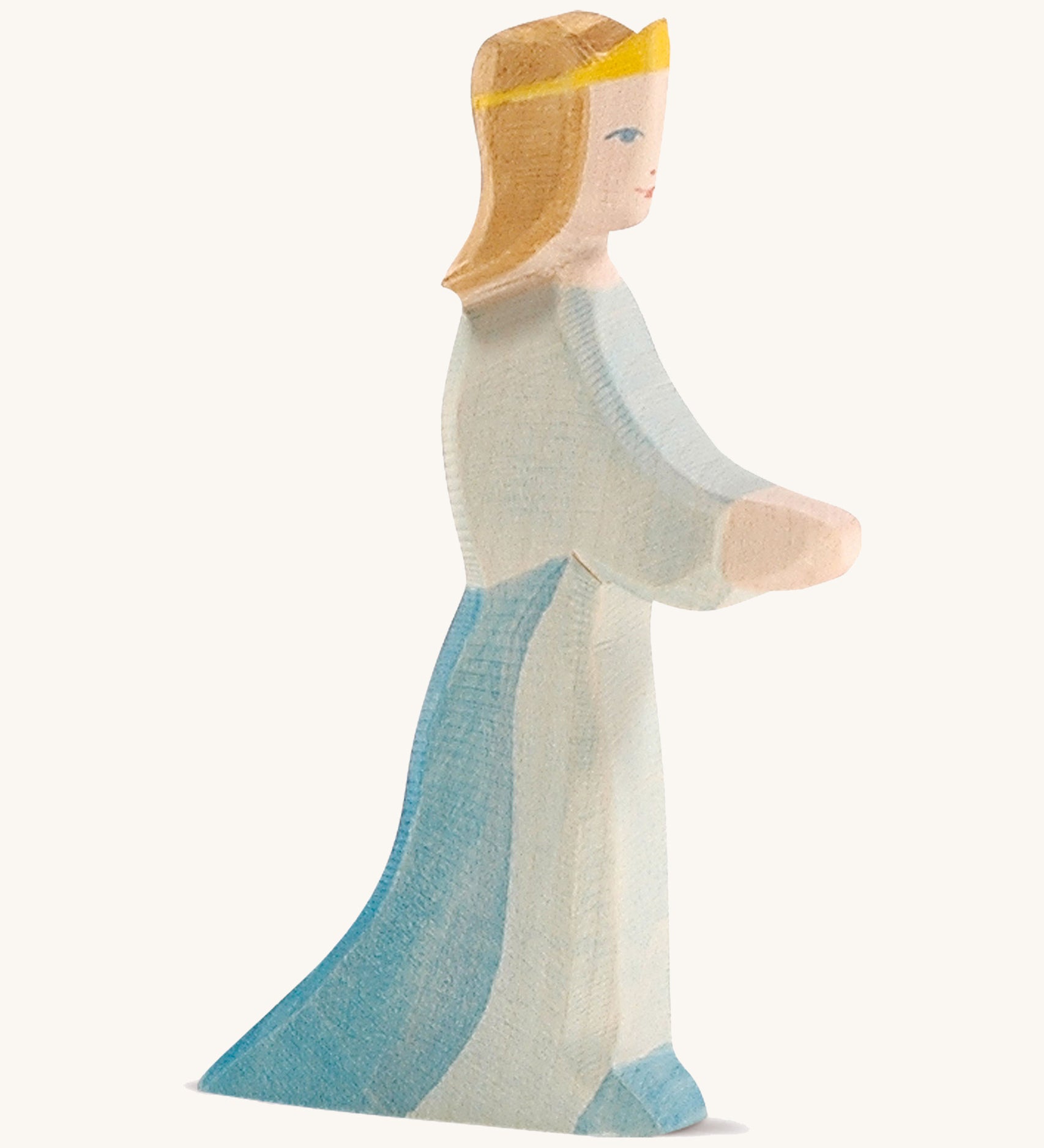 A wooden Ostheimer queen figure wearing a blue flowing dress and yellow tiara on a cream background.