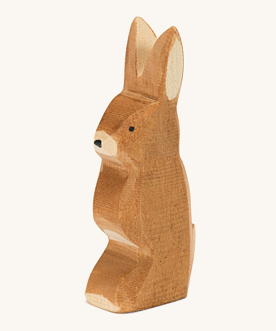 A wooden Ostheimer rabbit figure with ears pointing up on a cream background.