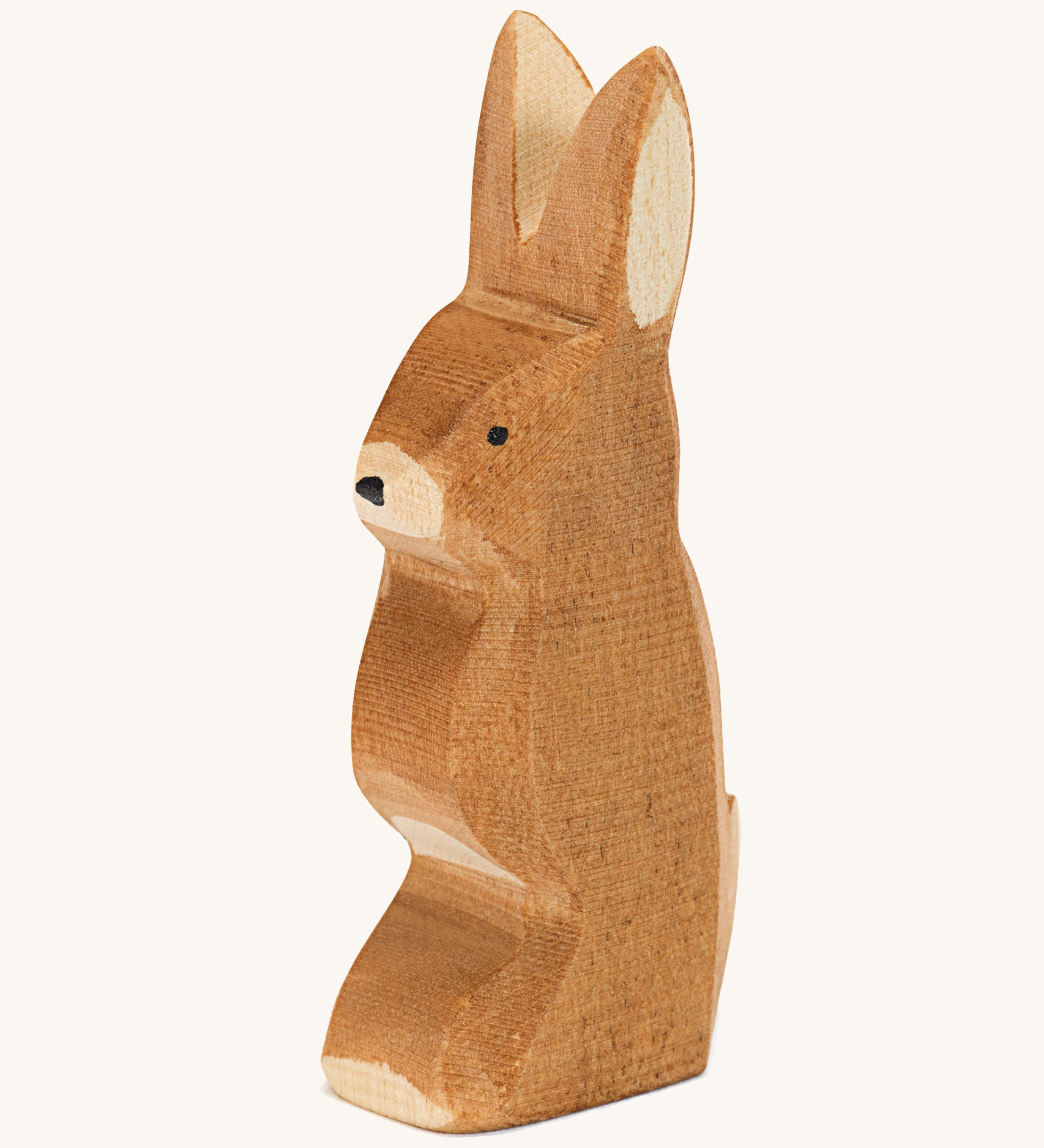 A wooden Ostheimer rabbit figure with ears pointing up on a cream background.