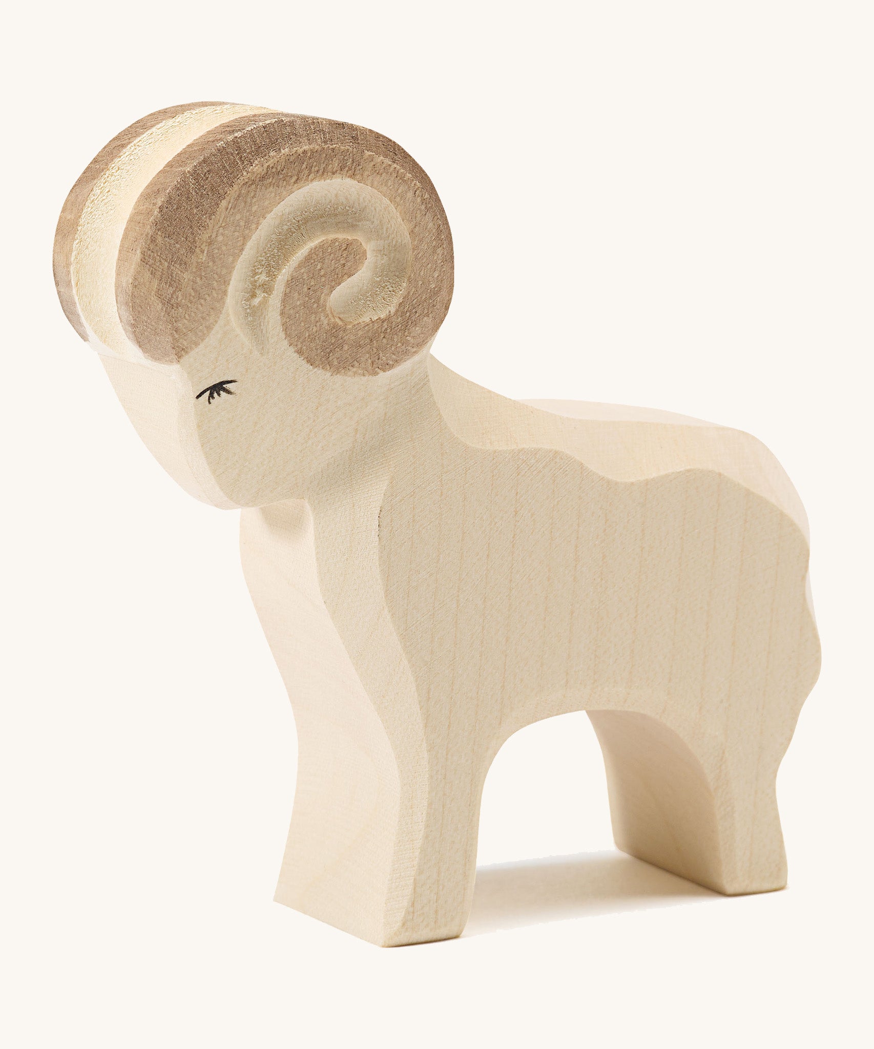 A white wooden Ostheimer standing ram figure on a cream background.